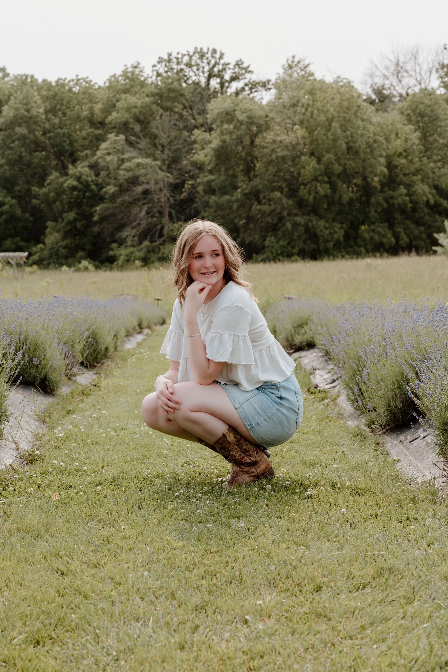 Light and airy photoshoot in a lavender field on a sunny day with casual summer fashion styling.