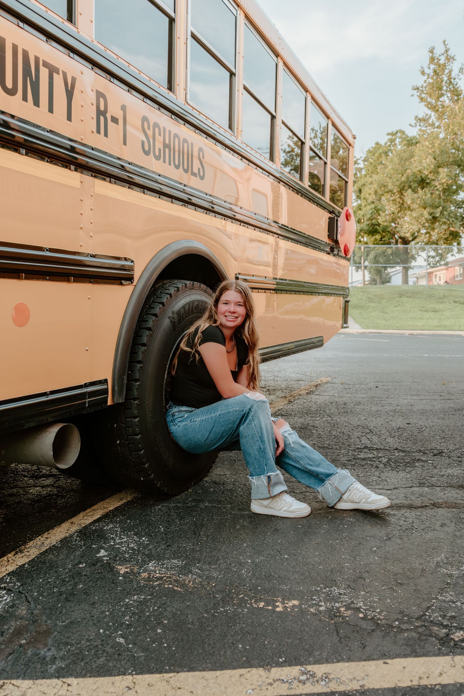 Playful photo sequence captured beneath and beside a parked school bus.