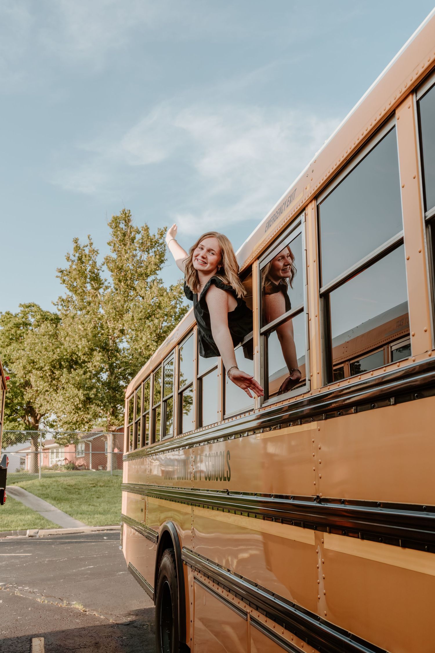 Creative angles capture someone leaning out of multiple school bus windows in a stylized photo series.