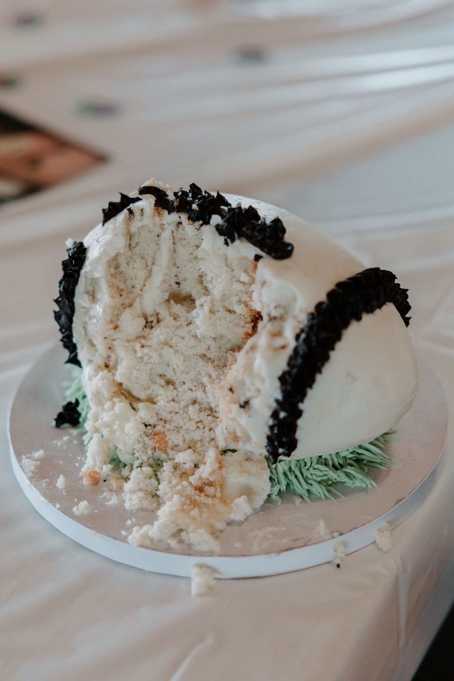 A sequence of images showing slices of white wedding cake with black frosting trim on white plates.