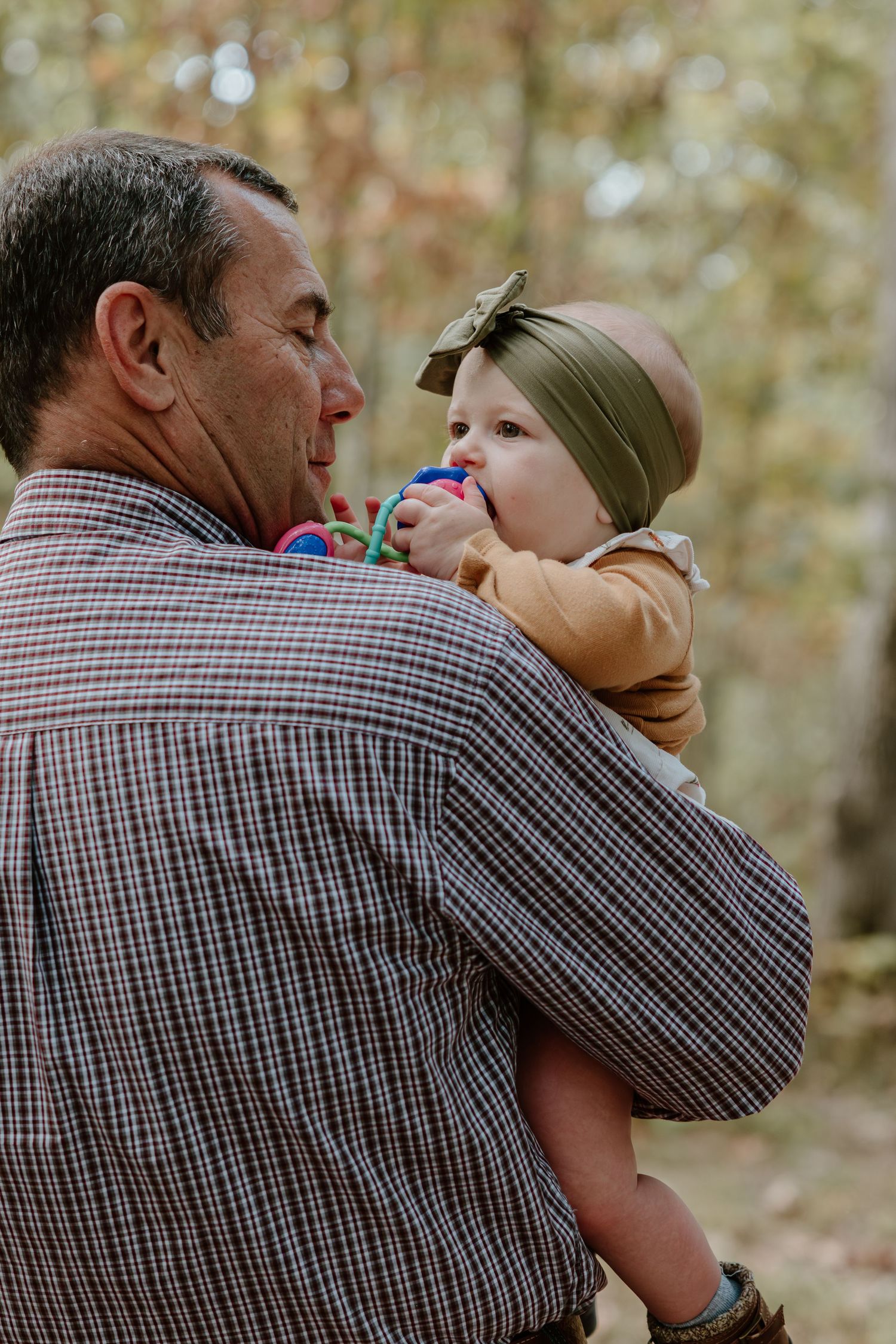 A series of candid outdoor photos showing tender moments between two people in a plaid shirt against a blurred nature backdrop.