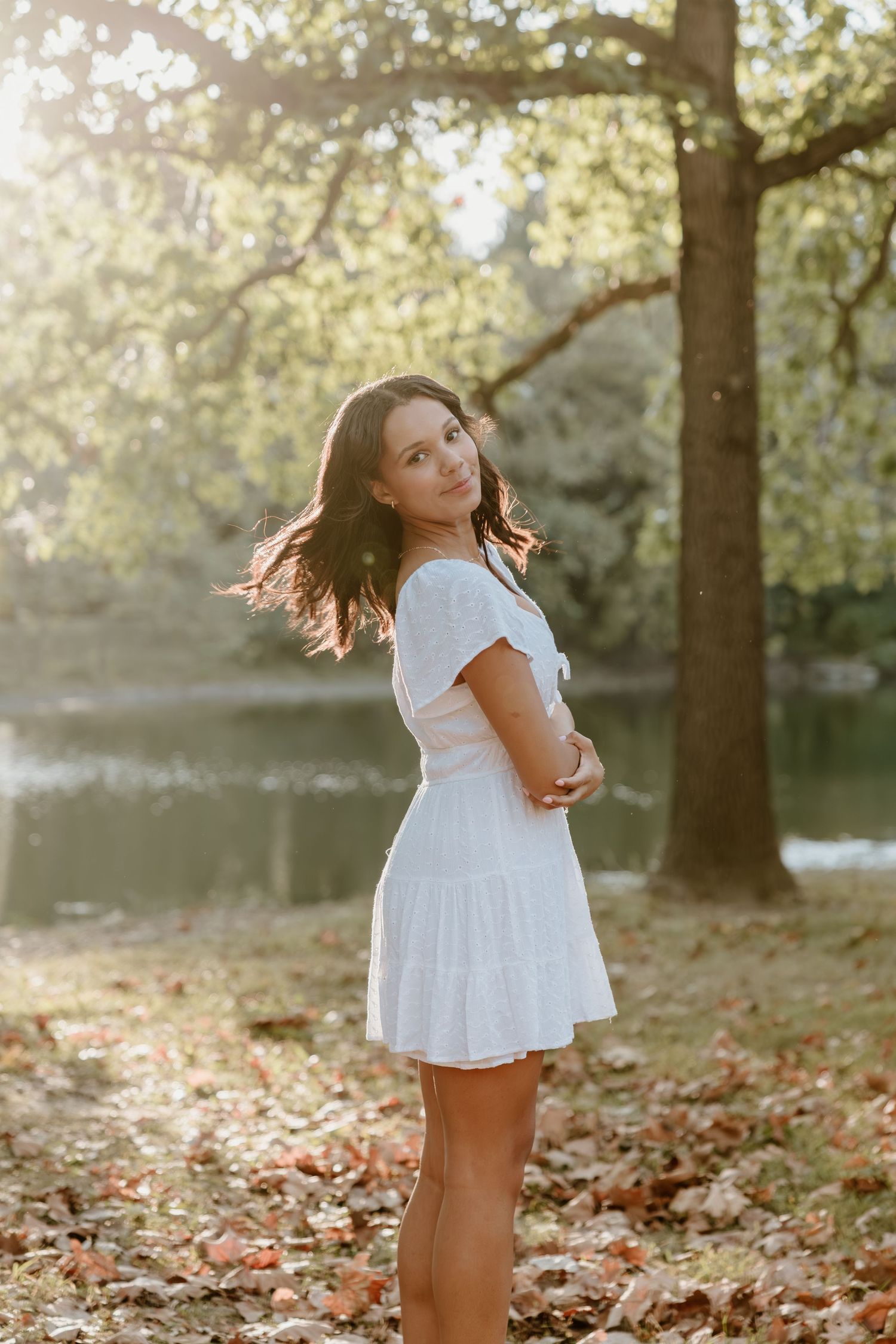 A sequence of dynamic poses captured in a sunlit outdoor setting with autumn leaves on the ground.