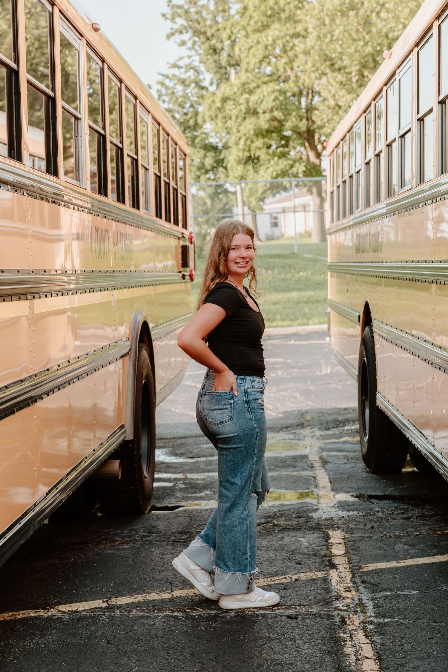 Four sequential shots showing dynamic poses alongside a school bus exterior.