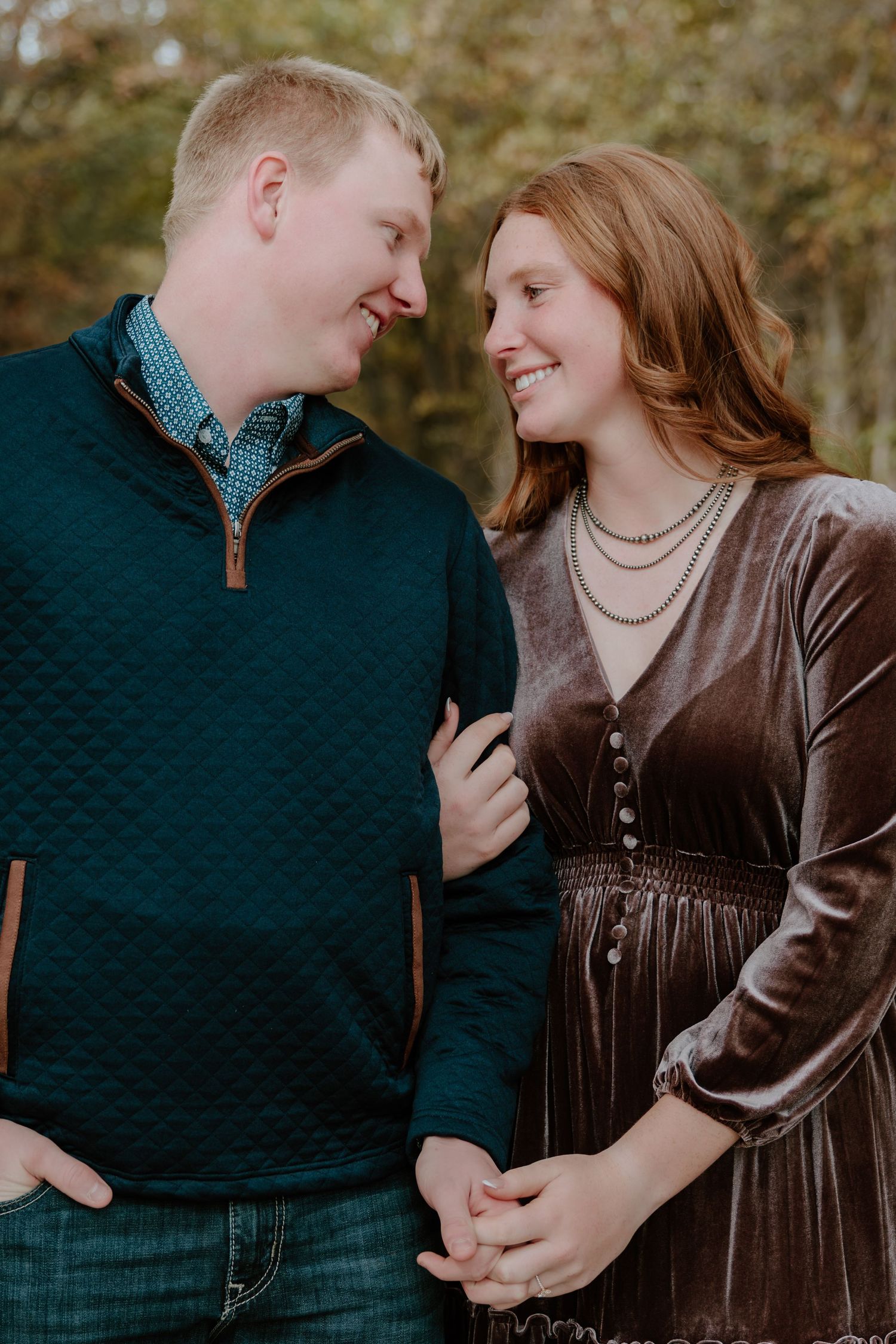A couple in casual attire share intimate moments in an autumn outdoor photoshoot series.