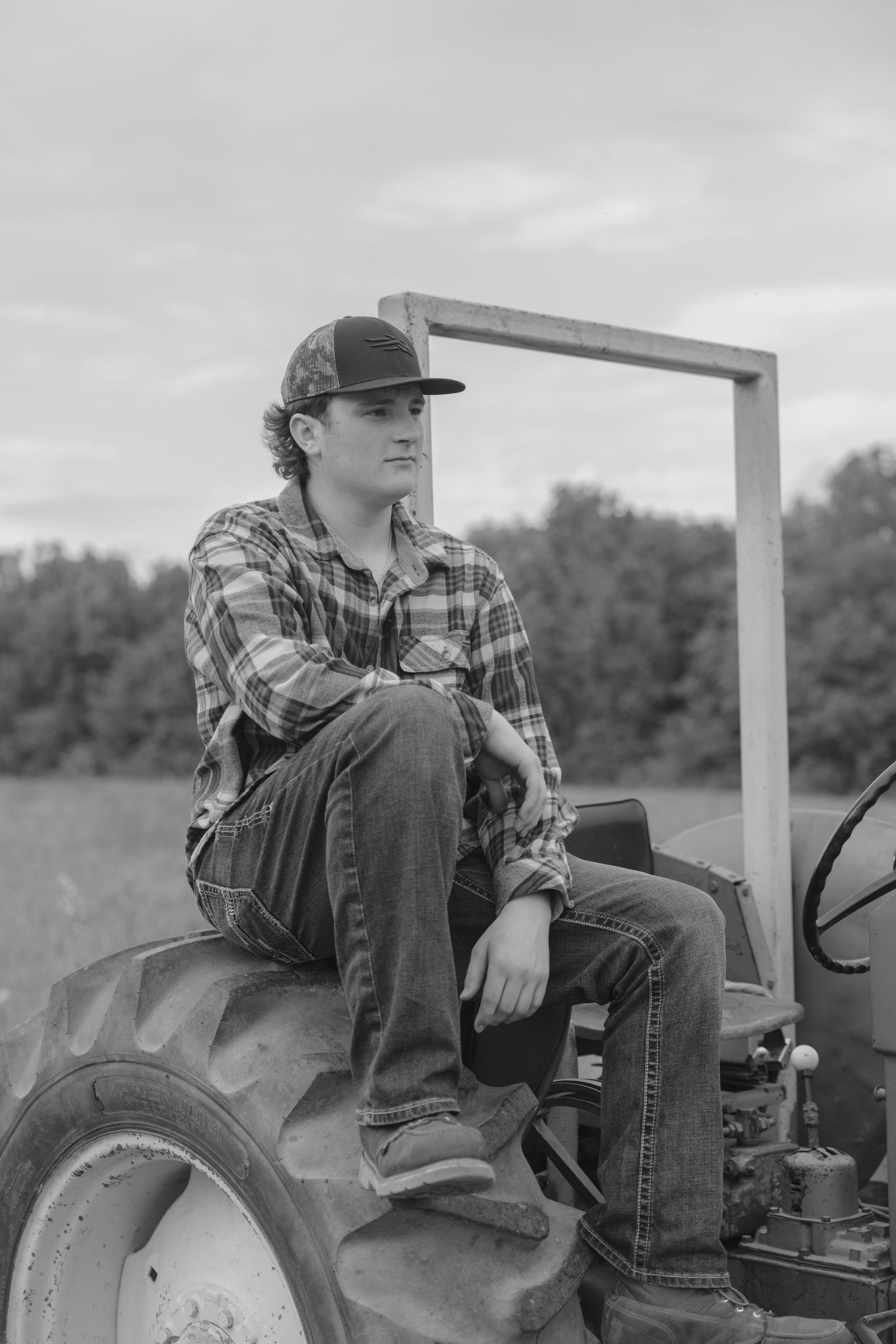 Vintage black and white photos show someone sitting on a tractor in casual farm work attire from multiple angles.