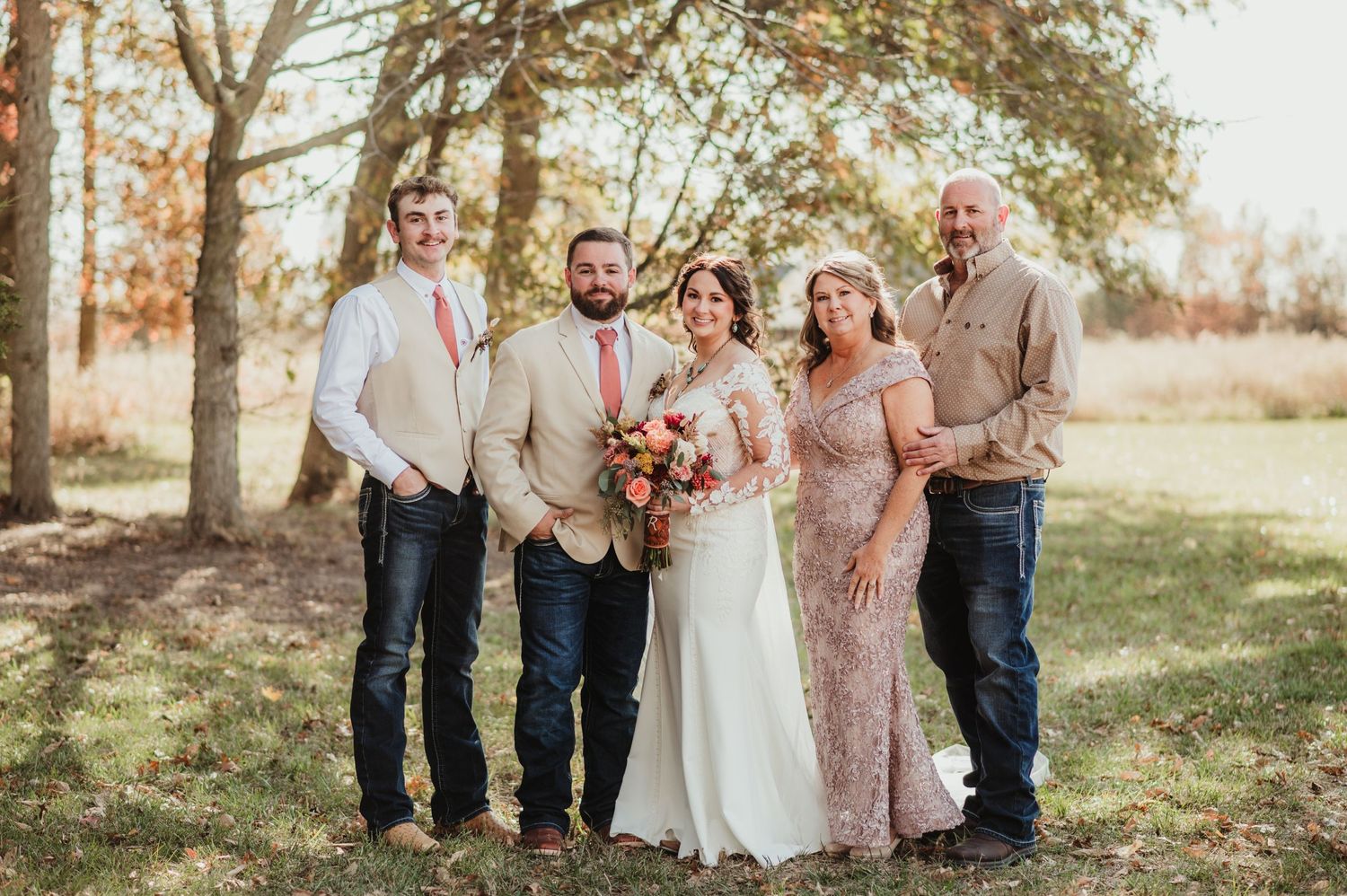 Lauren with her husband and family at their wedding