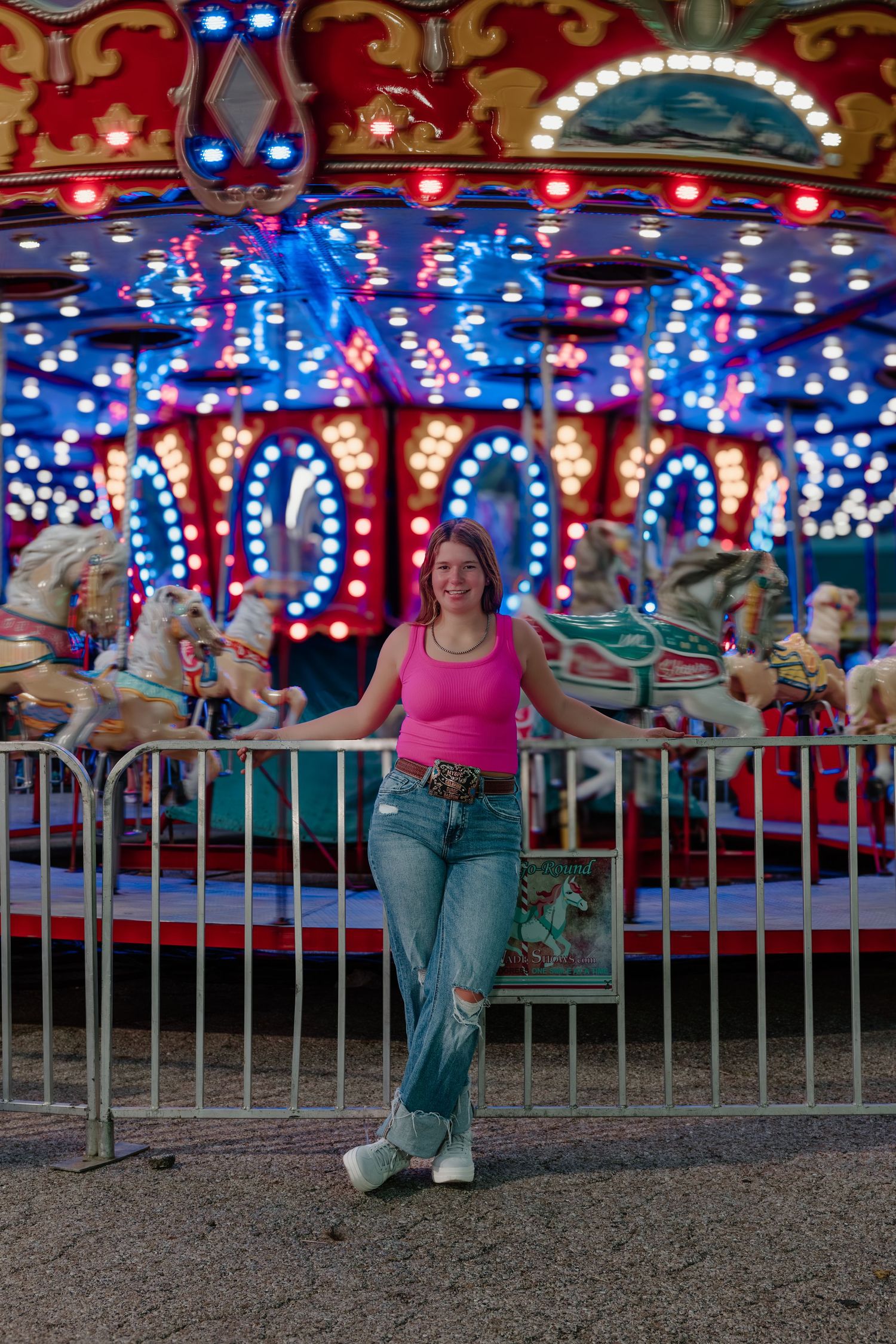 A sequence of photos showing a person in a pink top and jeans swinging under colorful carnival lights at an amusement park.