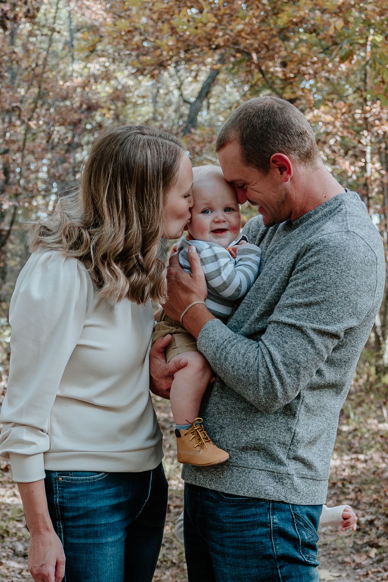 A family shares tender moments together in a series of candid photos taken outdoors during autumn.