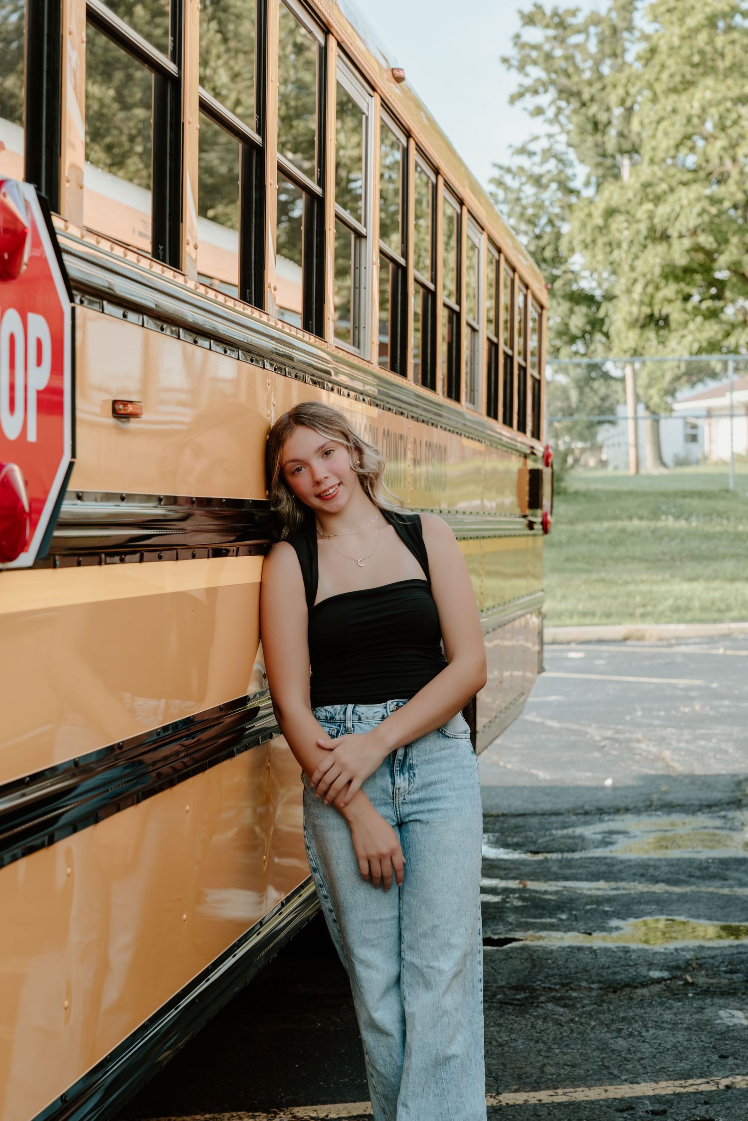 A series of stylized photo poses next to a yellow school bus on a sunny day.
