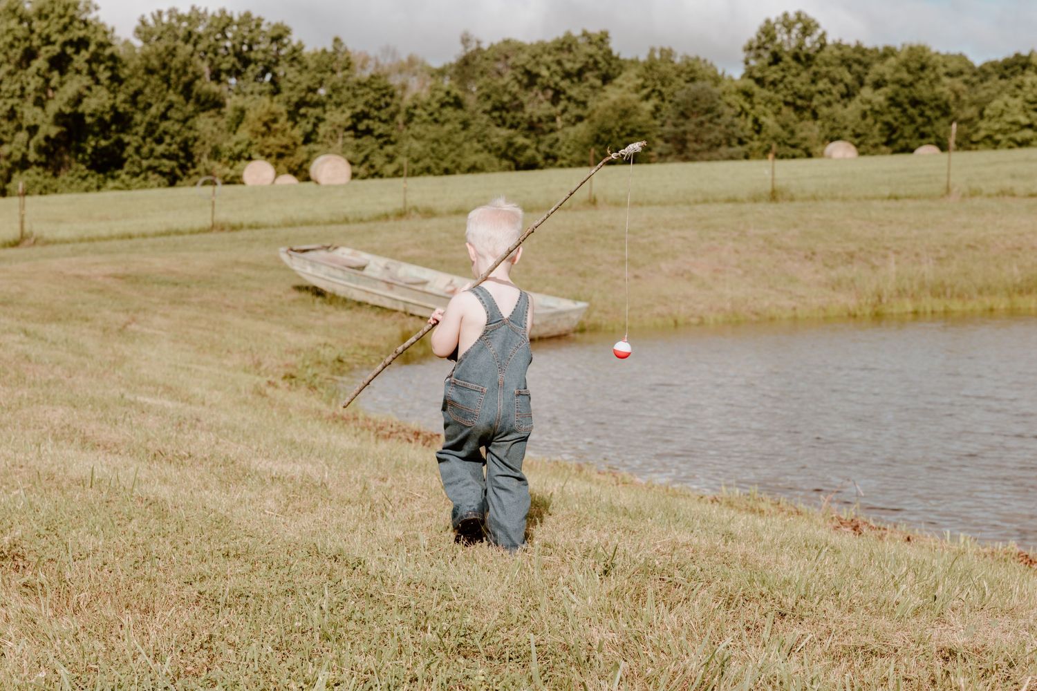 Multiple scenic views of a person fishing at the edge of a serene lake on a sunny day.