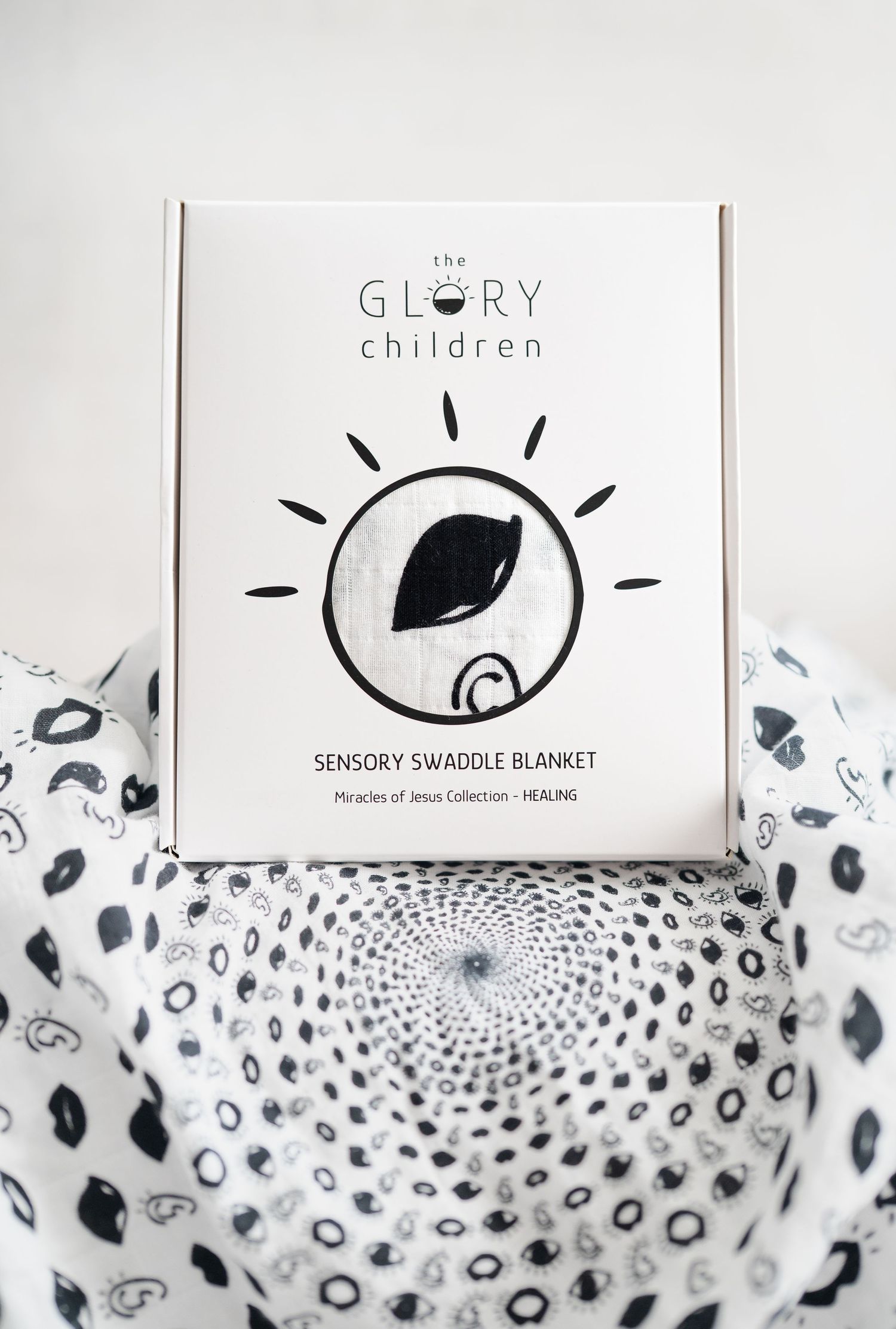 Product image: Glory Children Sensory Swaddle Blanket box from Miracles of Jesus Collection, Healing edition, with black and white pattern.