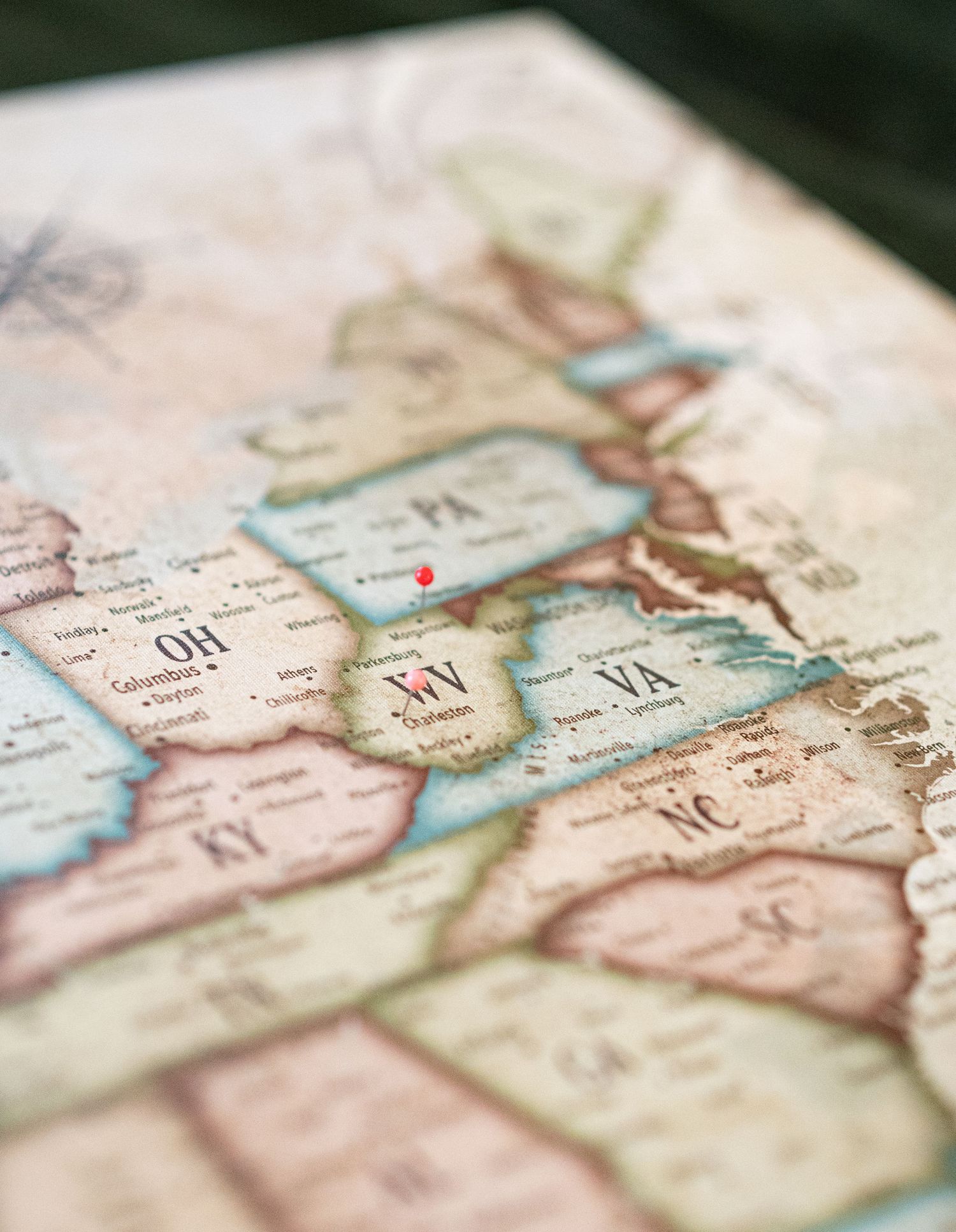 closeup product photo of a map of the USA with pins in it