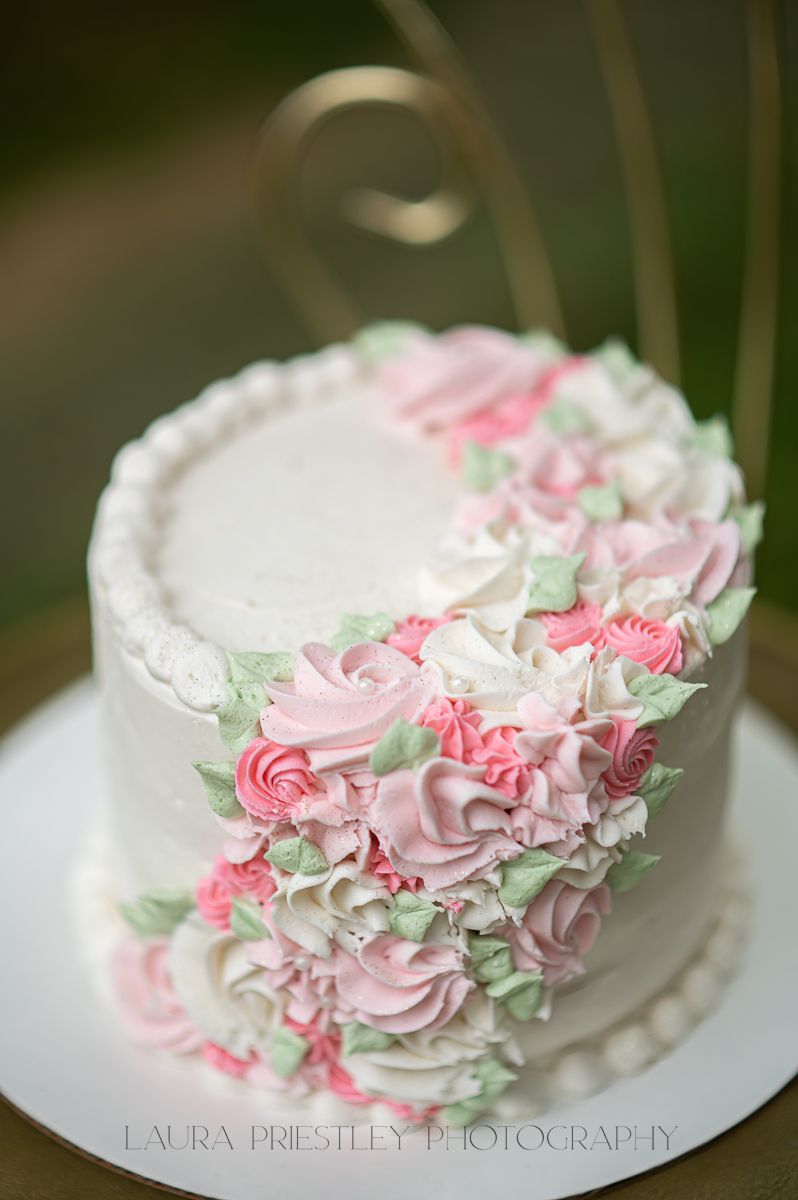 an elaborate floral birthday cake covered in icing roses and leaves