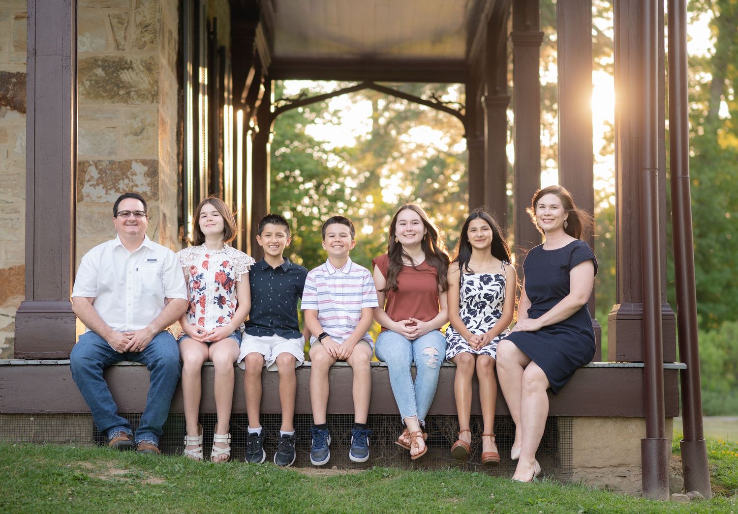 a family of seven pose and smile for a family portrait at the Albert Gallatin House in Friendship Hill in Point Marion, PA