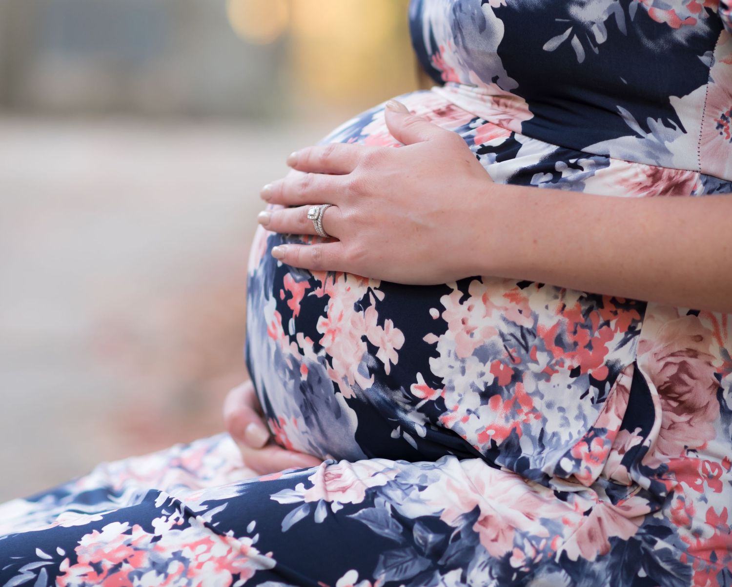 closeup of a woman's round pregnant belly with her hands, at Cooper's Rock State Park in WV