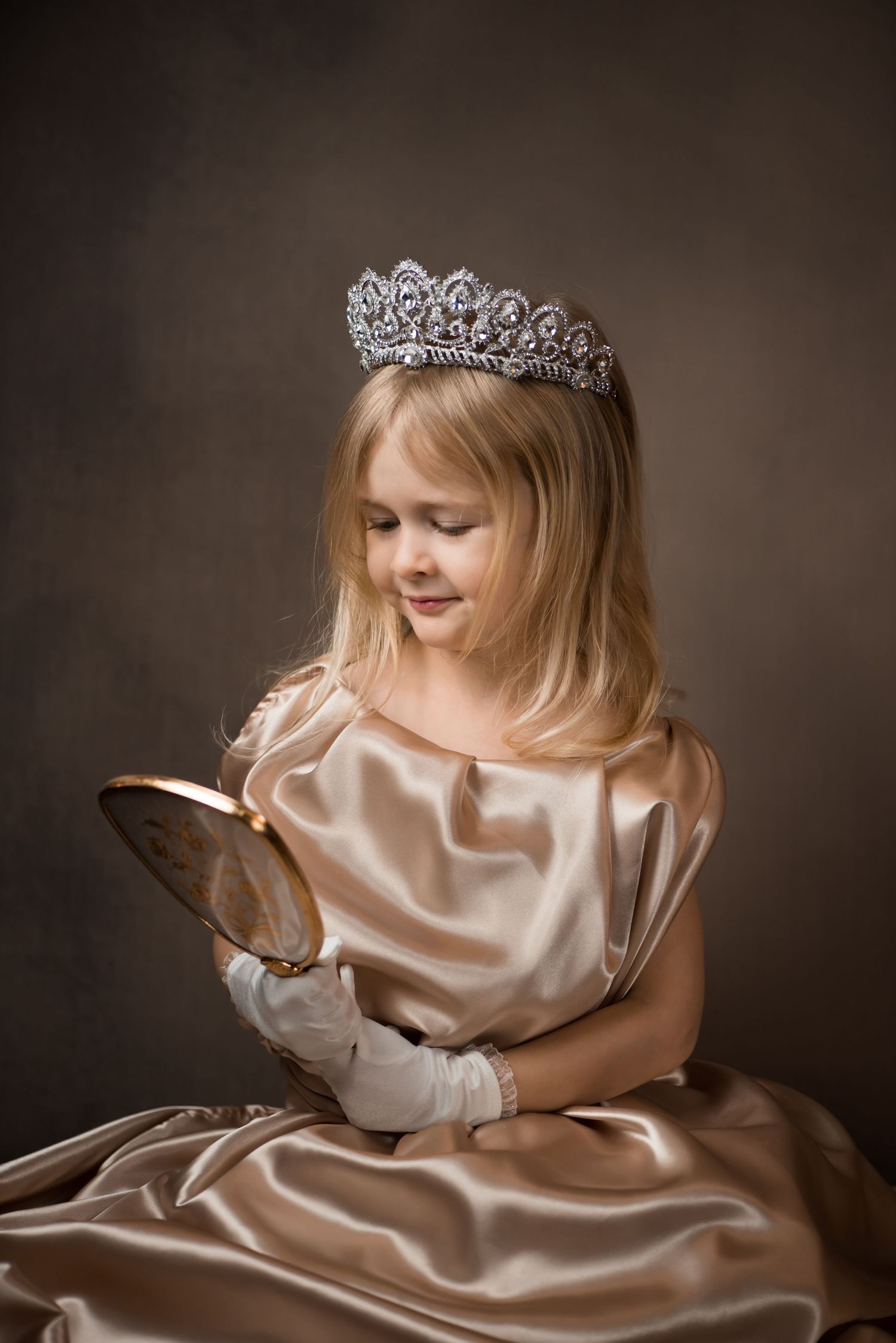 classical old masters style portrait of a little blonde girl in a gold dress and crown, looking into a vintage gold hand mirror