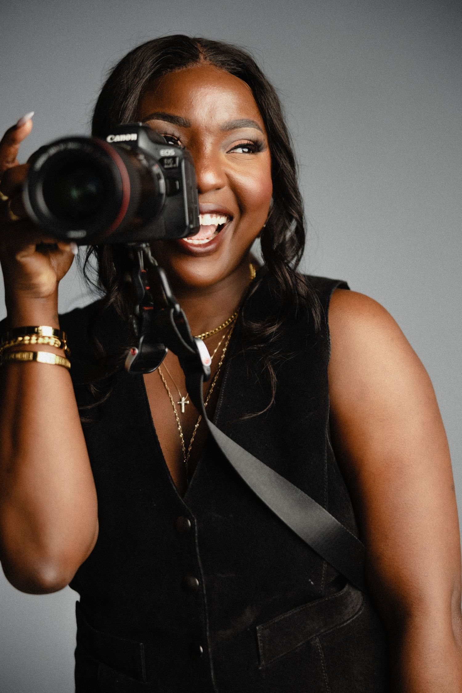 woman smiling while holding camera up