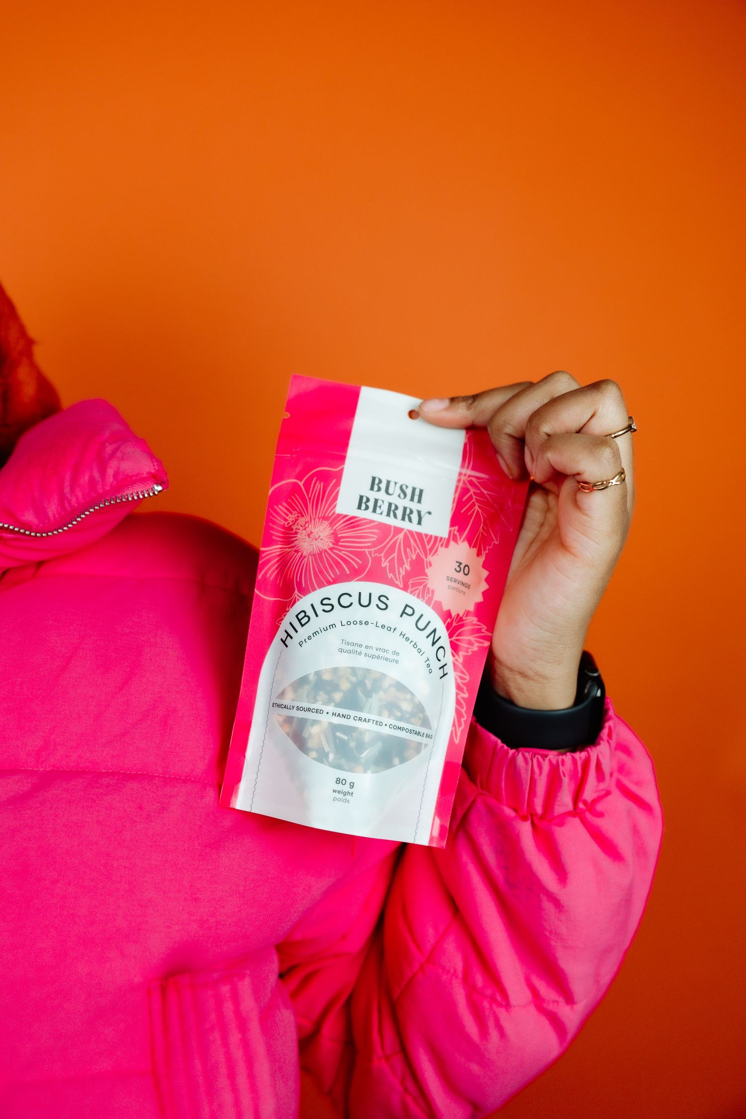 holding pink hibiscus punch tea