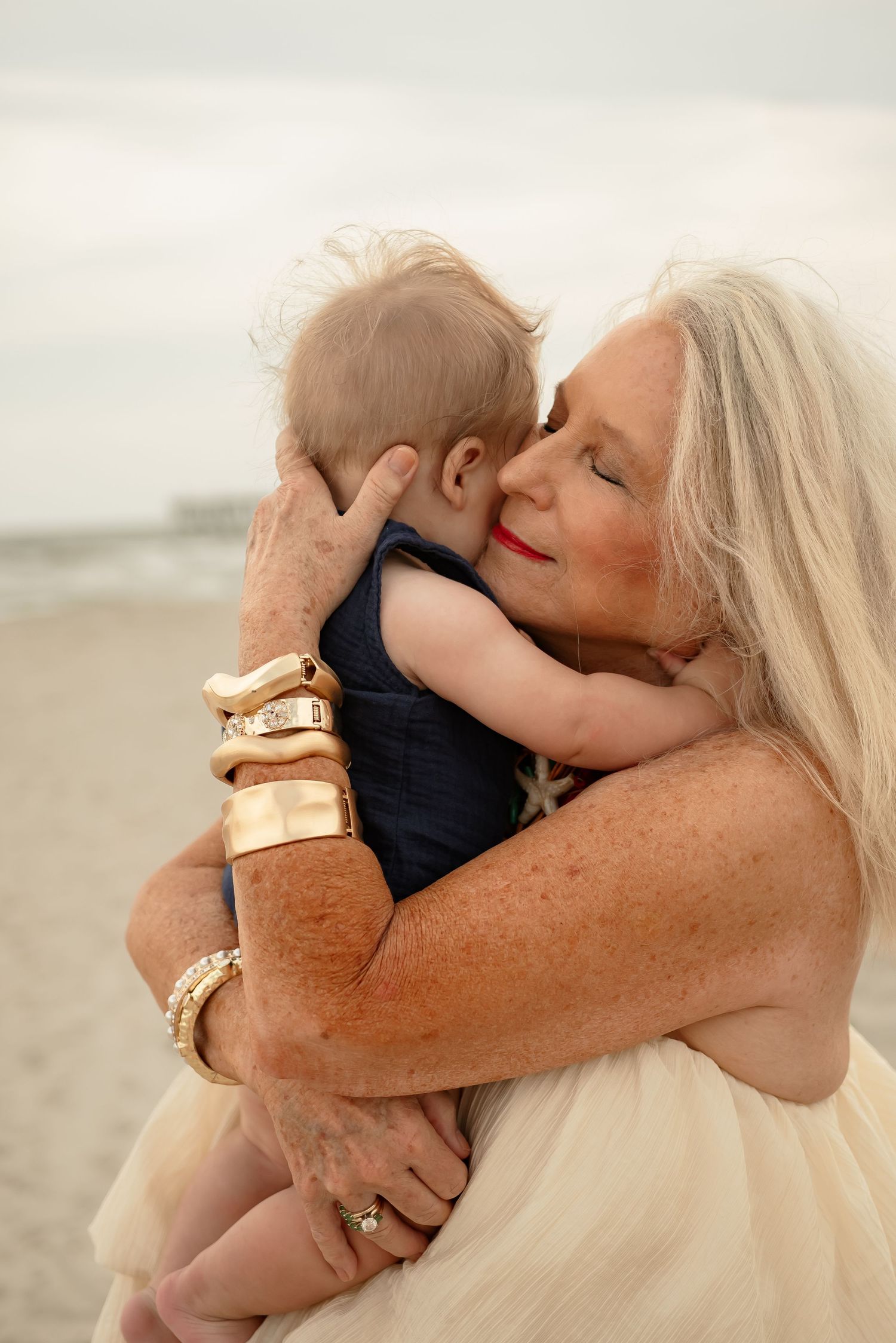 Emotional moments shared between family members in warm evening light on a sandy beach.