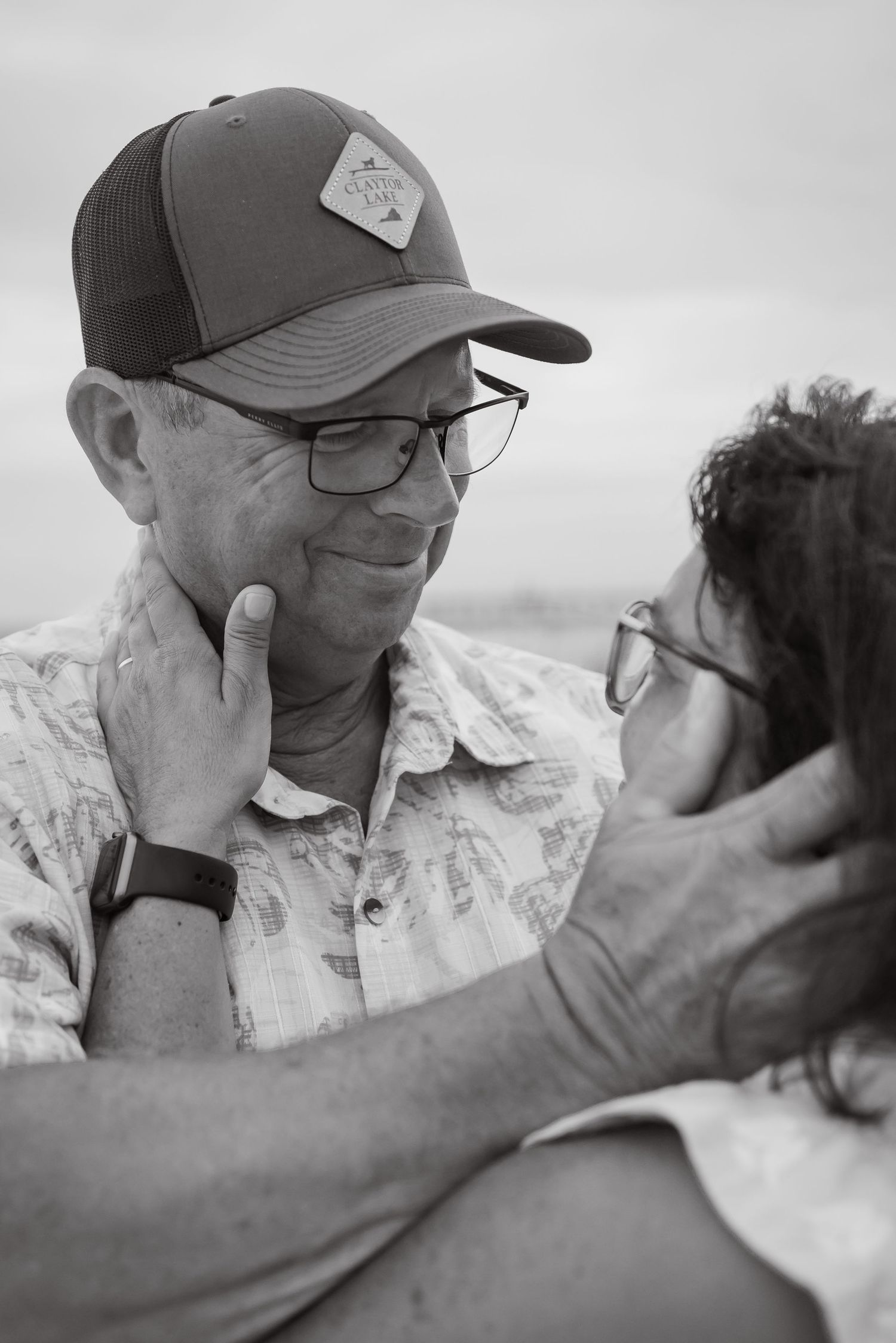 Black and white close-up shots capturing intimate family moments outdoors.