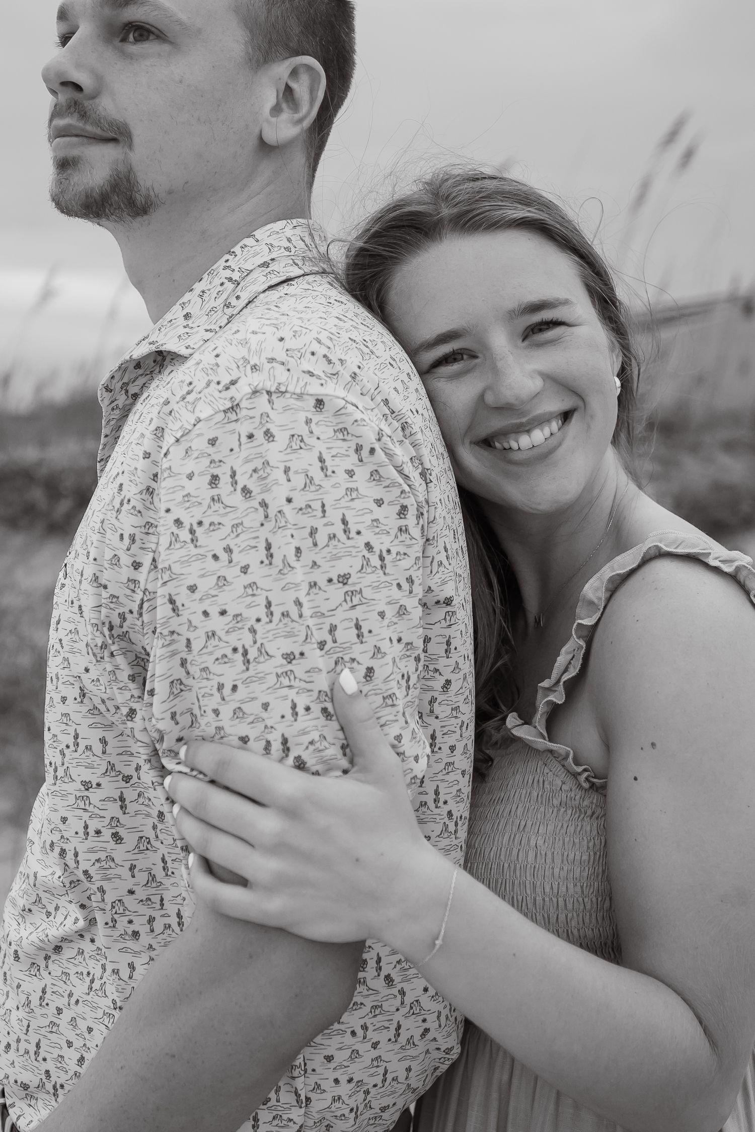 Black and white portraits showing affectionate embraces against a natural backdrop.