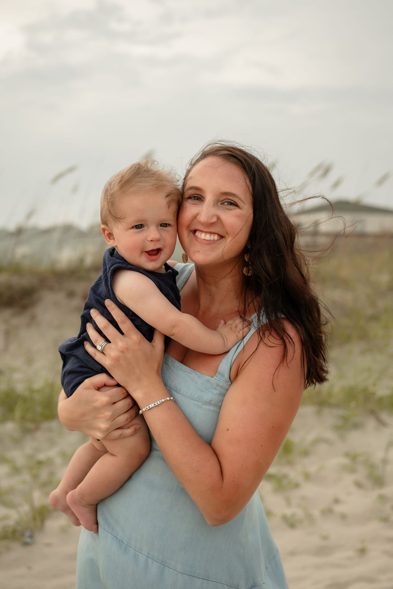 Candid beach portraits showing joyful interactions against coastal dunes.
