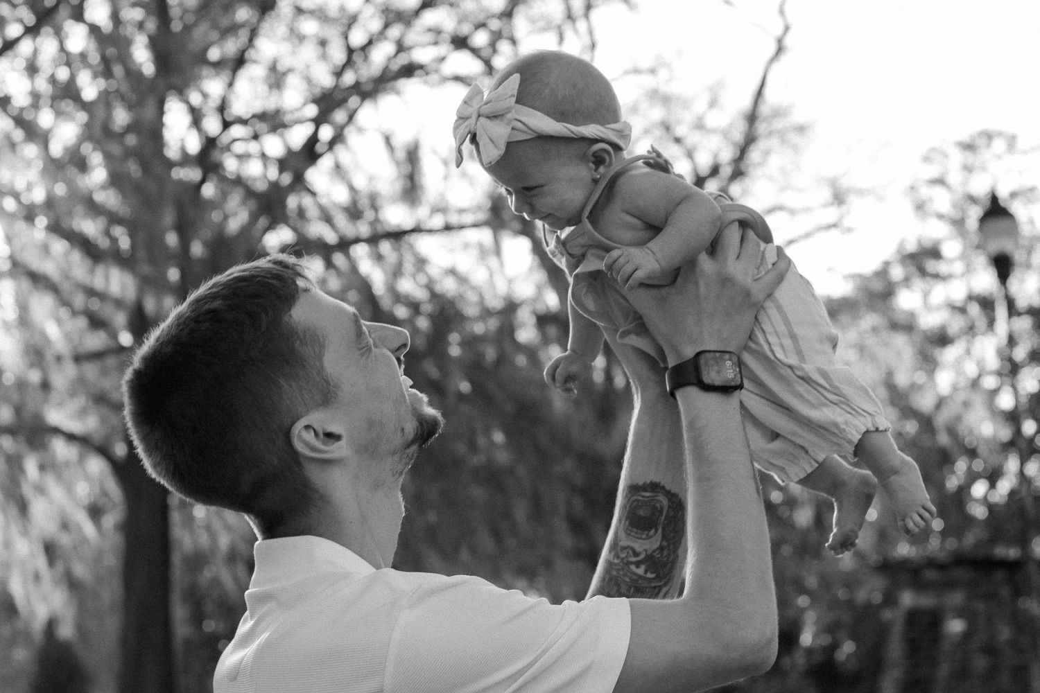 Black and white candid shots capturing playful interactions between parent and child.
