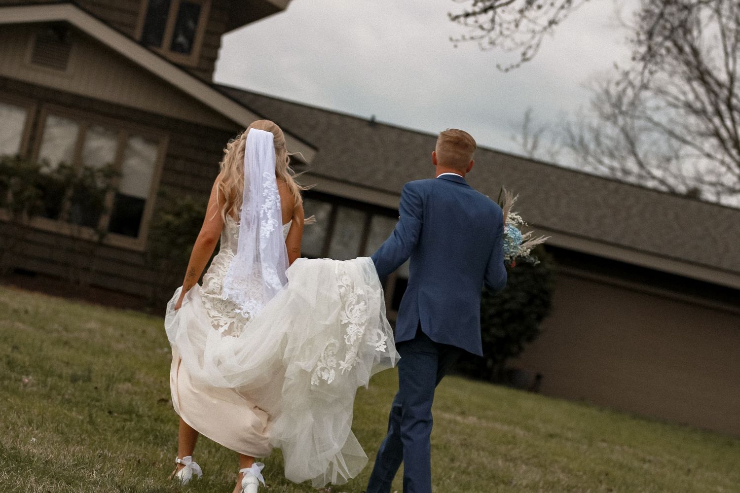 Newlywed couple walking together outside their venue after ceremony.