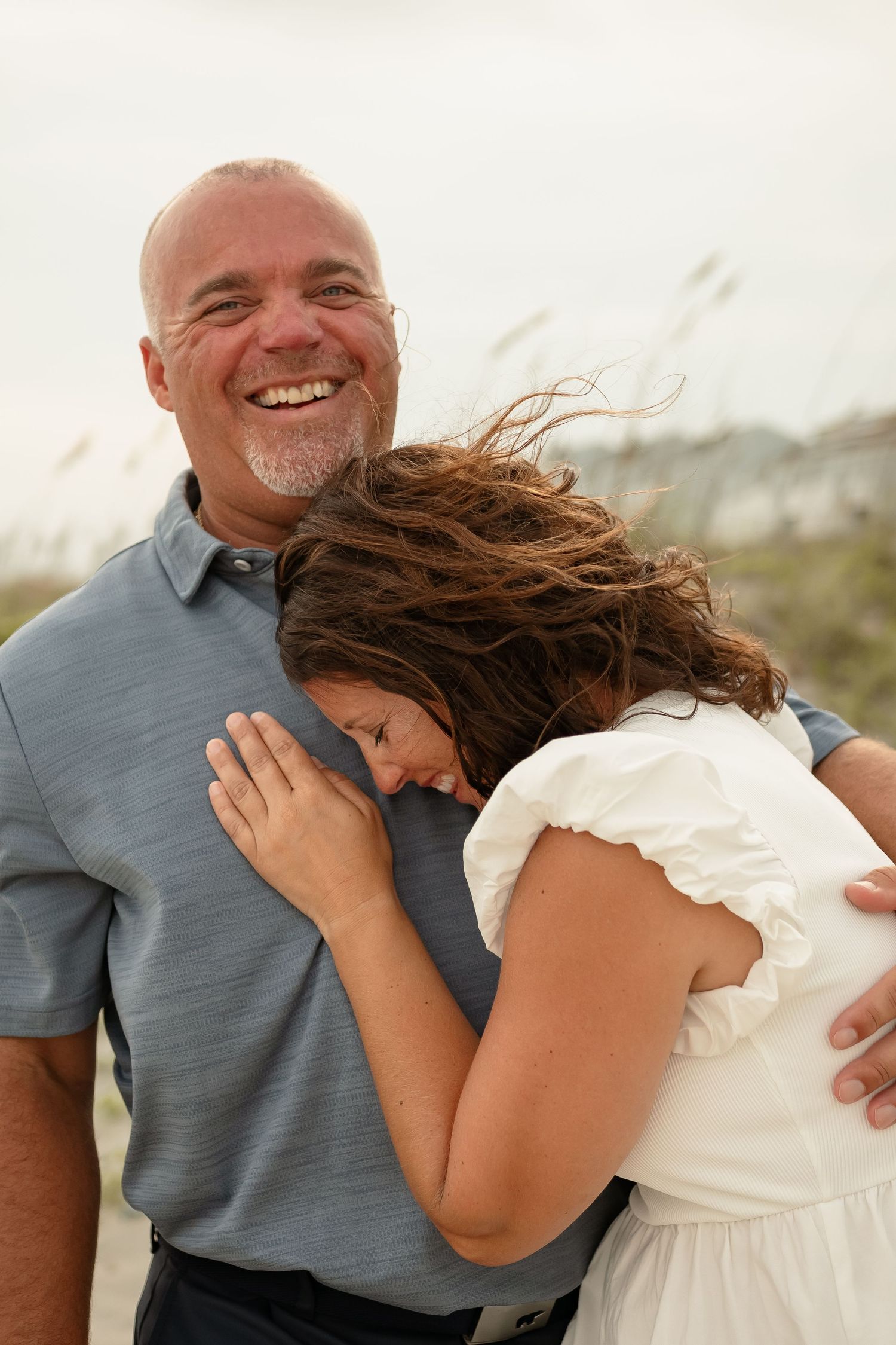 Candid sequence of a father and daughter sharing joyful moments at the beach.