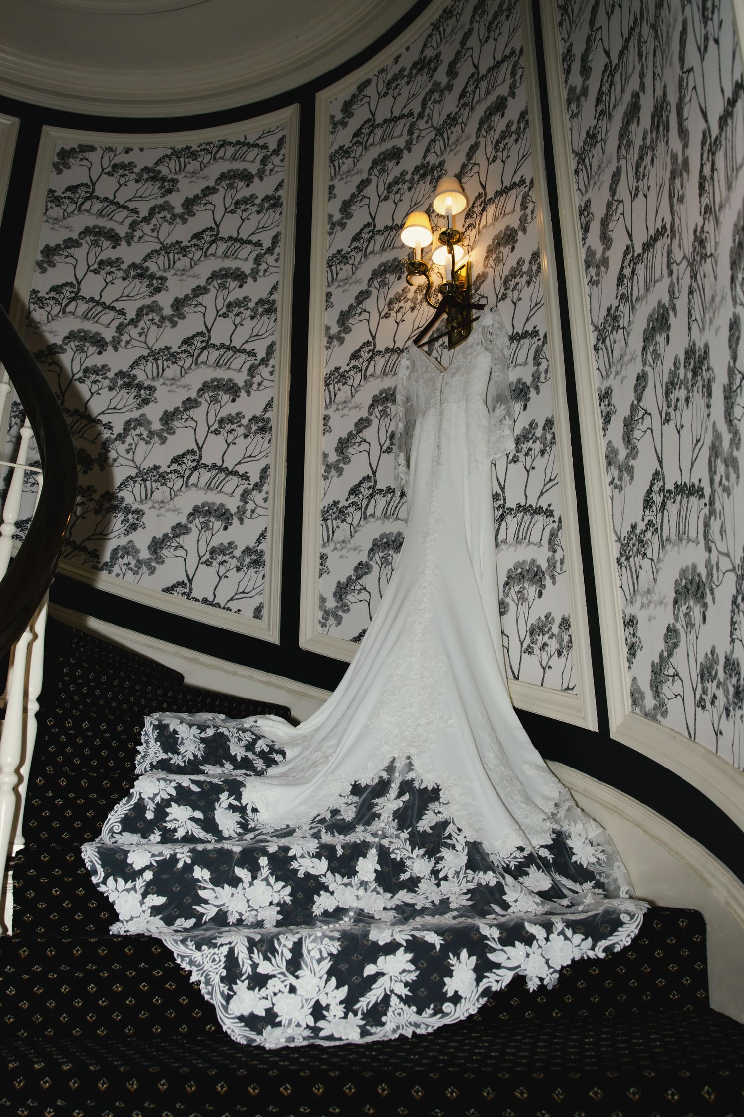 A series of photos showing white lace details on a flowing wedding dress train laid out on a black polka dot surface.