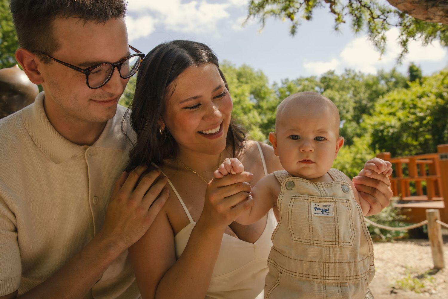 A happy family enjoying a sunny outdoor moment in a garden setting with blurred images showing natural lighting.