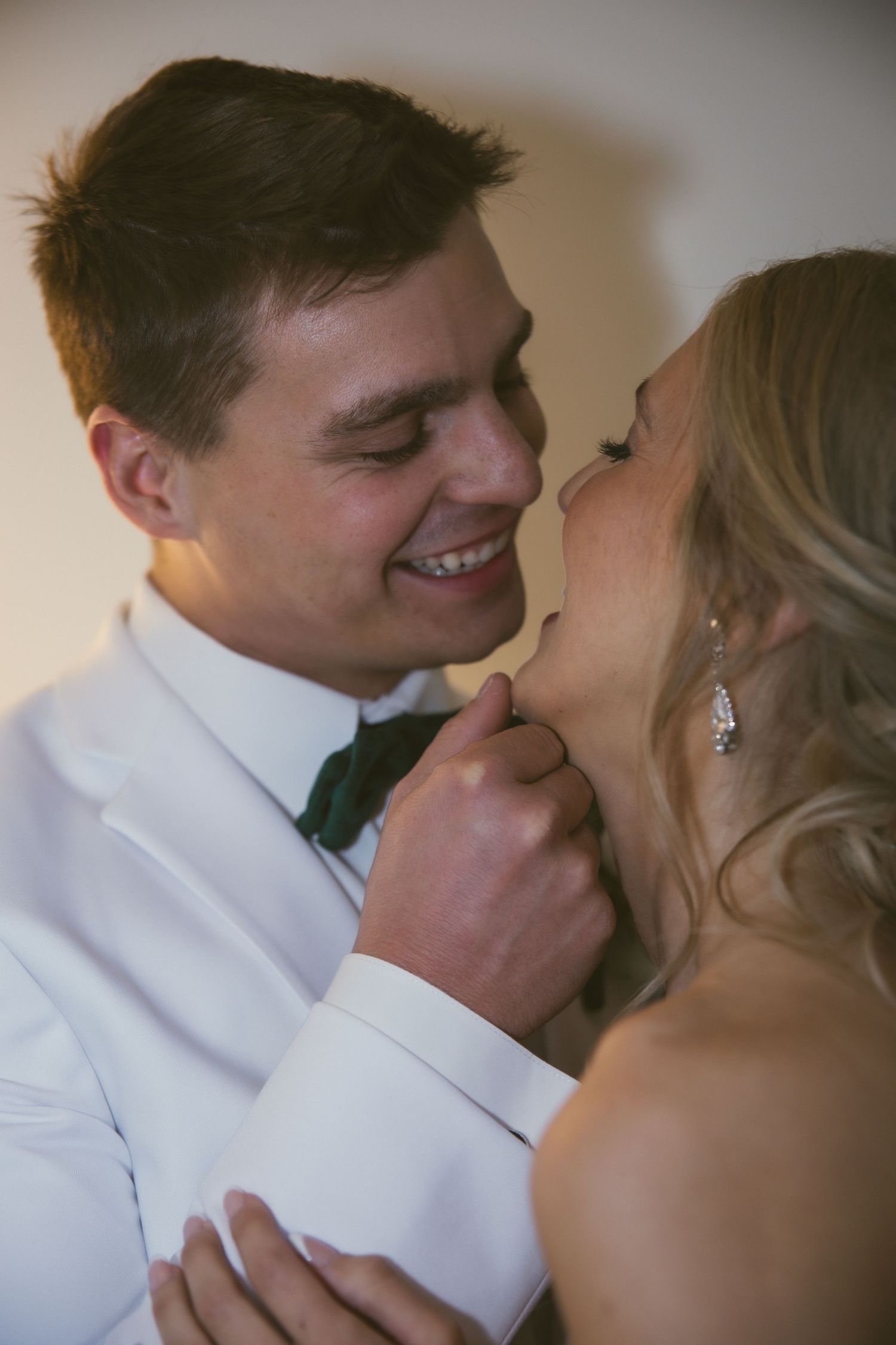 A tender close-up moment between newlyweds sharing laughter.
