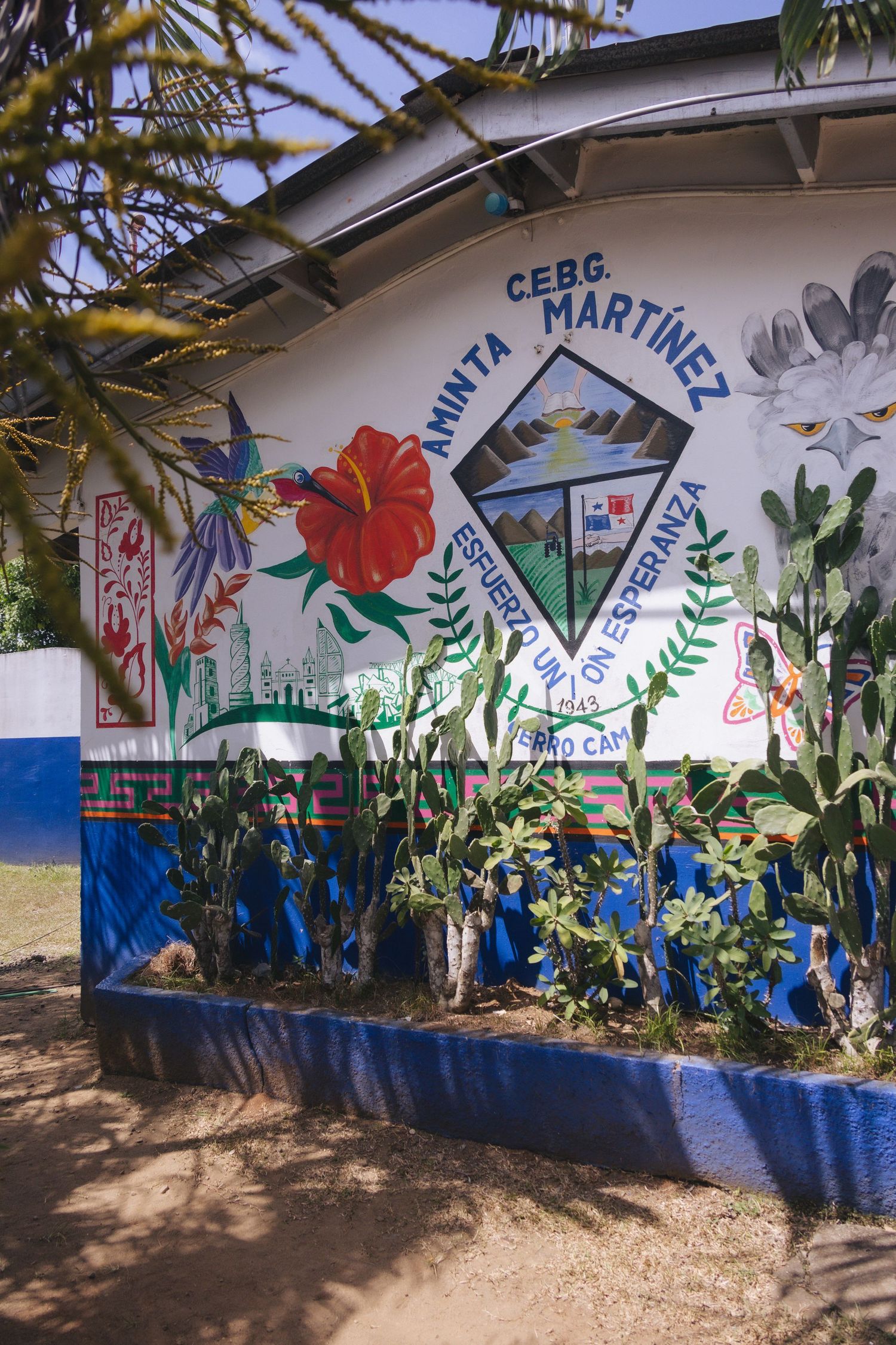 Colorful mural on CEBG Aminta Martinez school wall with flowers and plants in Honduras.