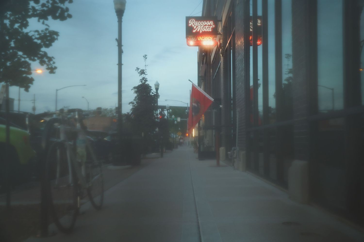 A collage of four dark storefront images shows rows of lit street lamps and moody evening city scenes.