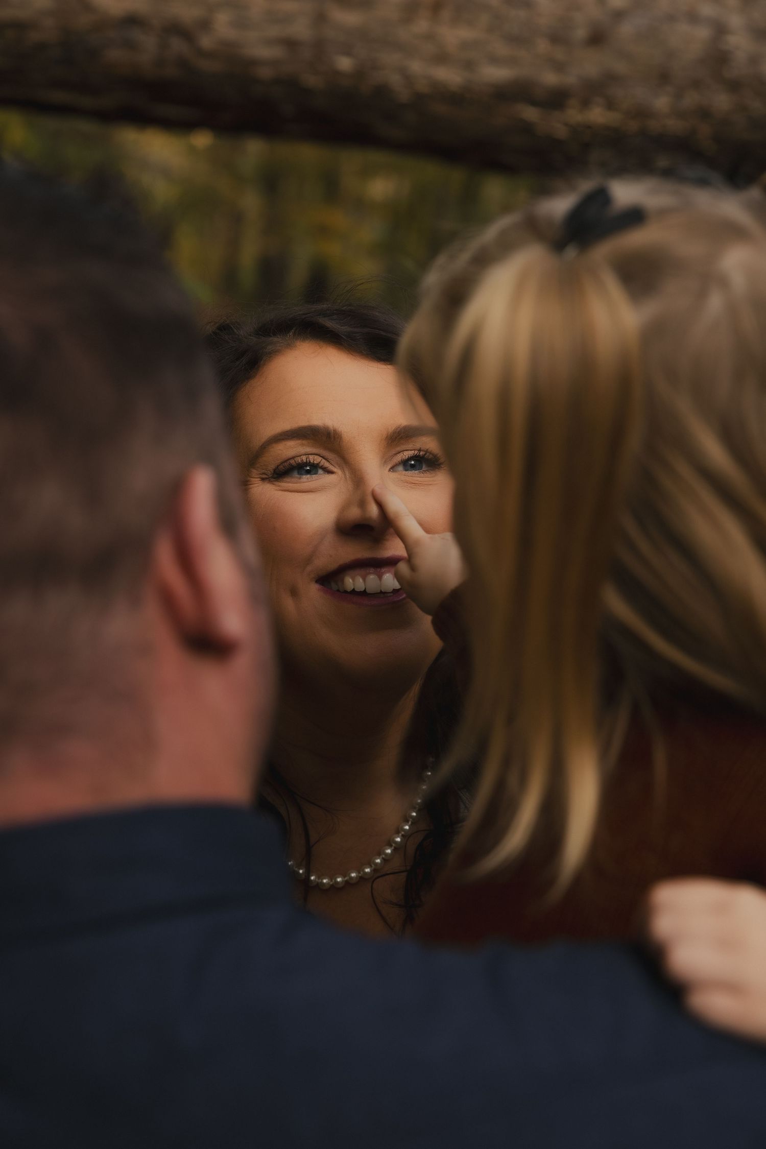 Close-up sequence of a couple sharing an intimate moment at an outdoor wedding ceremony.
