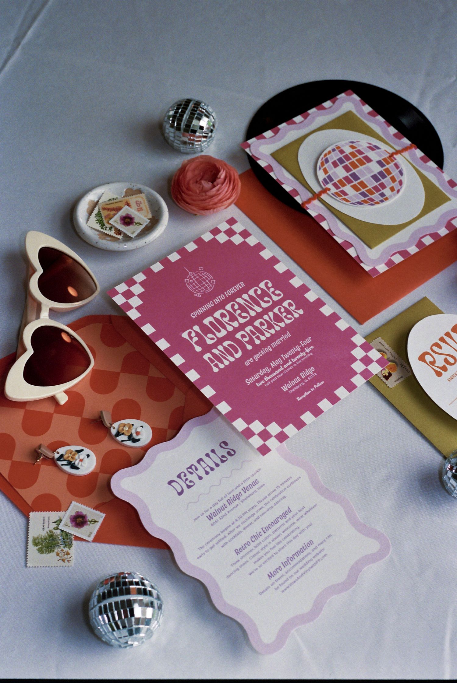 Retro wedding invitation designs with heart-shaped sunglasses, disco balls, and pink and orange themed decor items.