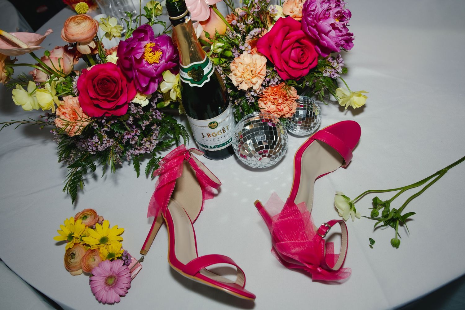 Collage of vibrant floral arrangements with pink and red roses mixed with greenery against a light background.
