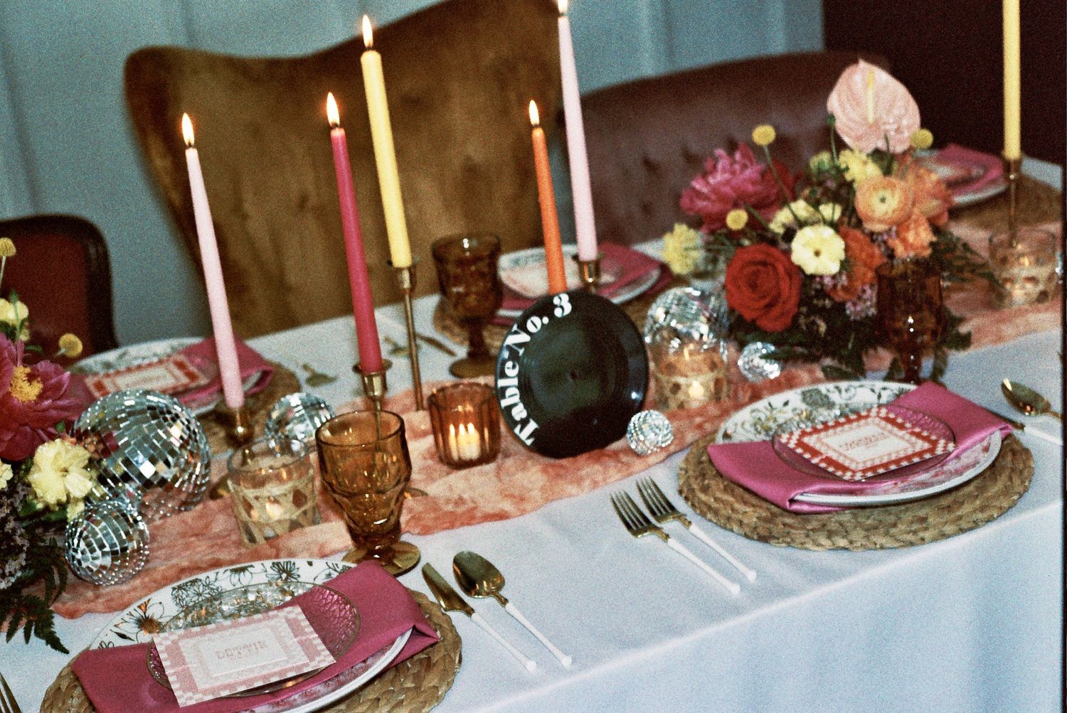 Wedding reception table settings feature elegant centerpieces, candles, and place settings in pink and gold tones.