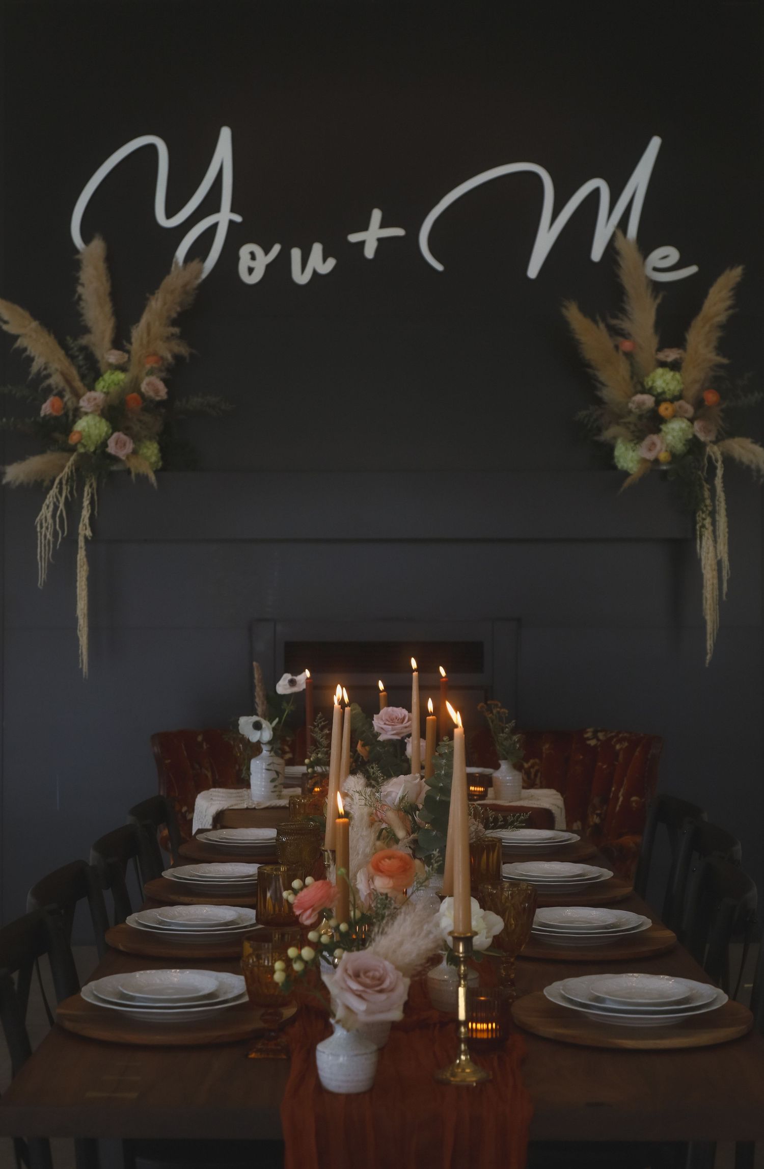 Romantic dinner table setting with lit candles and 