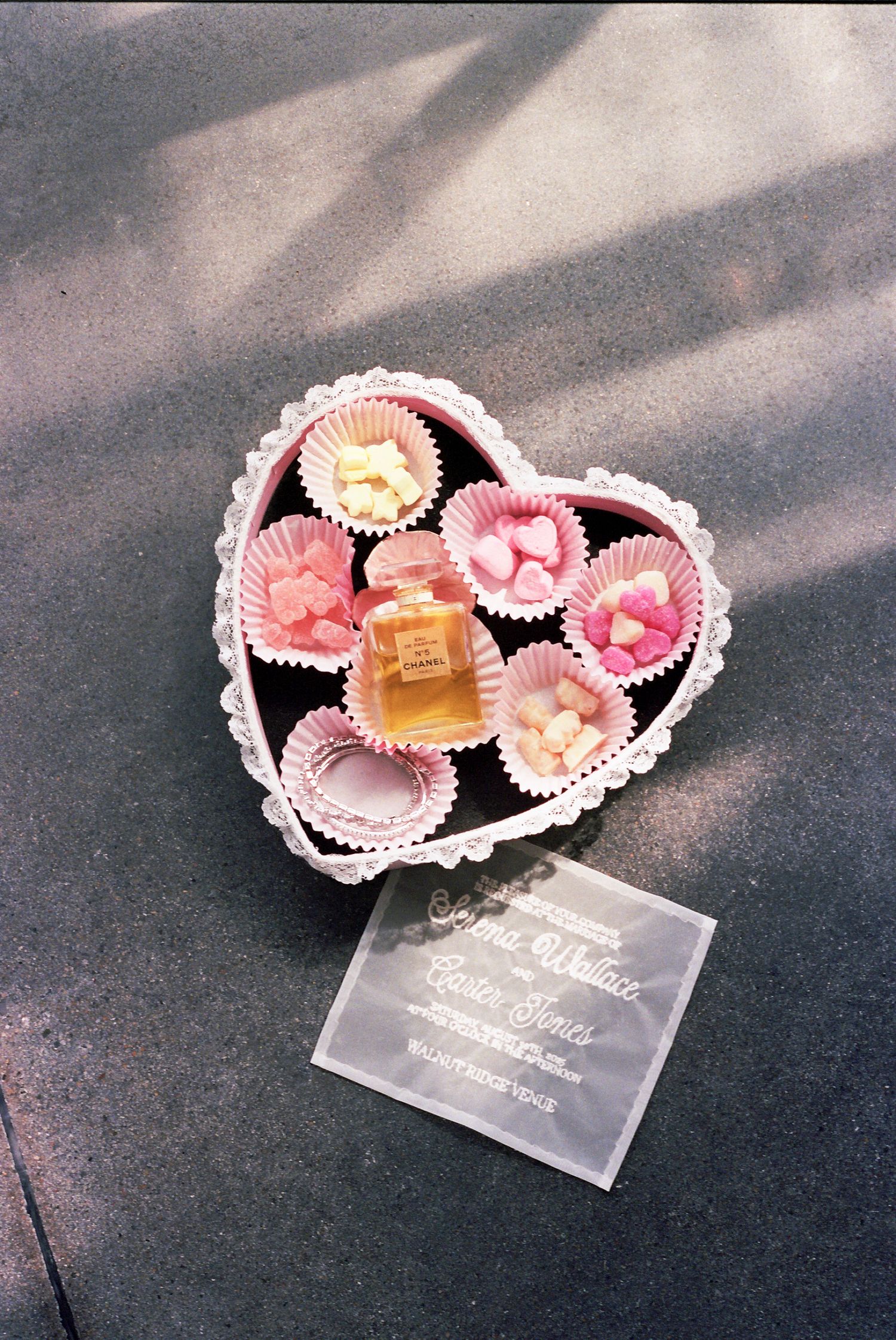 A sequence showing heart-shaped pink paper petals and clear acrylic tags arranged in a romantic display.