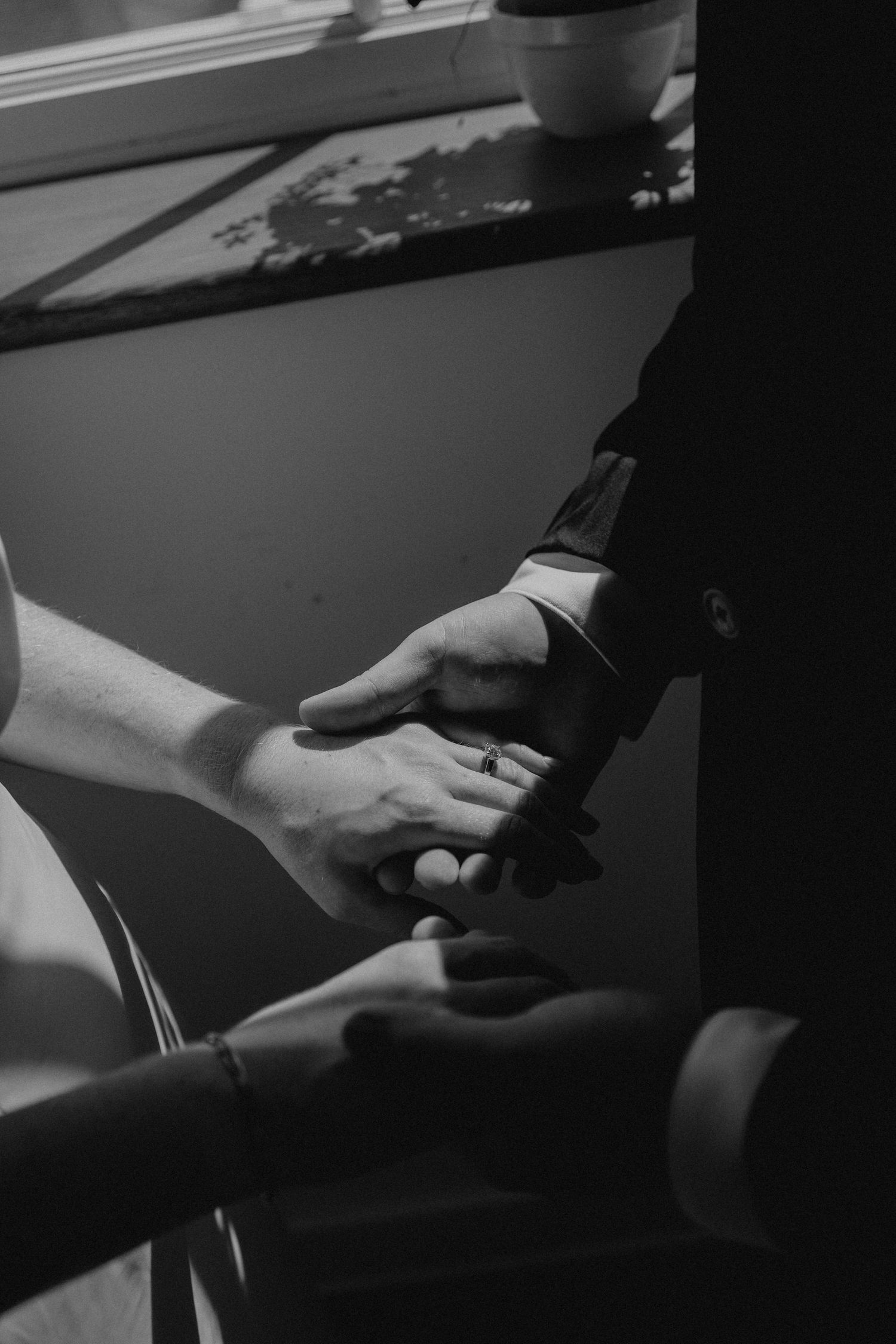Close-up of hands exchanging rings during wedding ceremony.