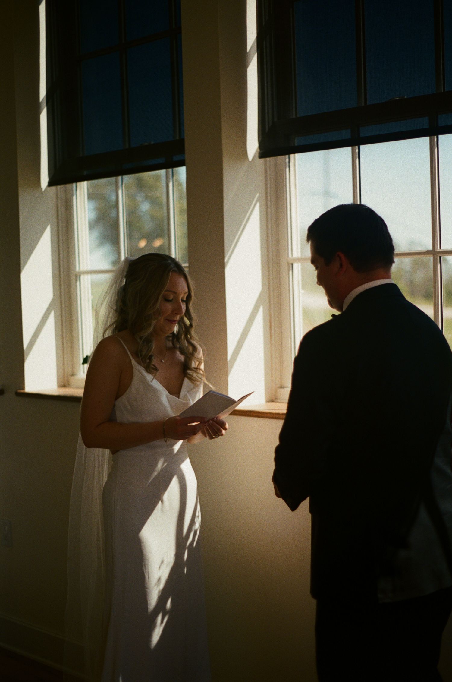 Silhouetted figures in a sunlit room creating dramatic shadows through large windows.