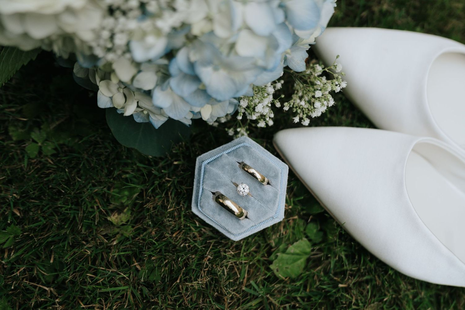 Wedding flowers and decor arranged on grass with delicate white petals.