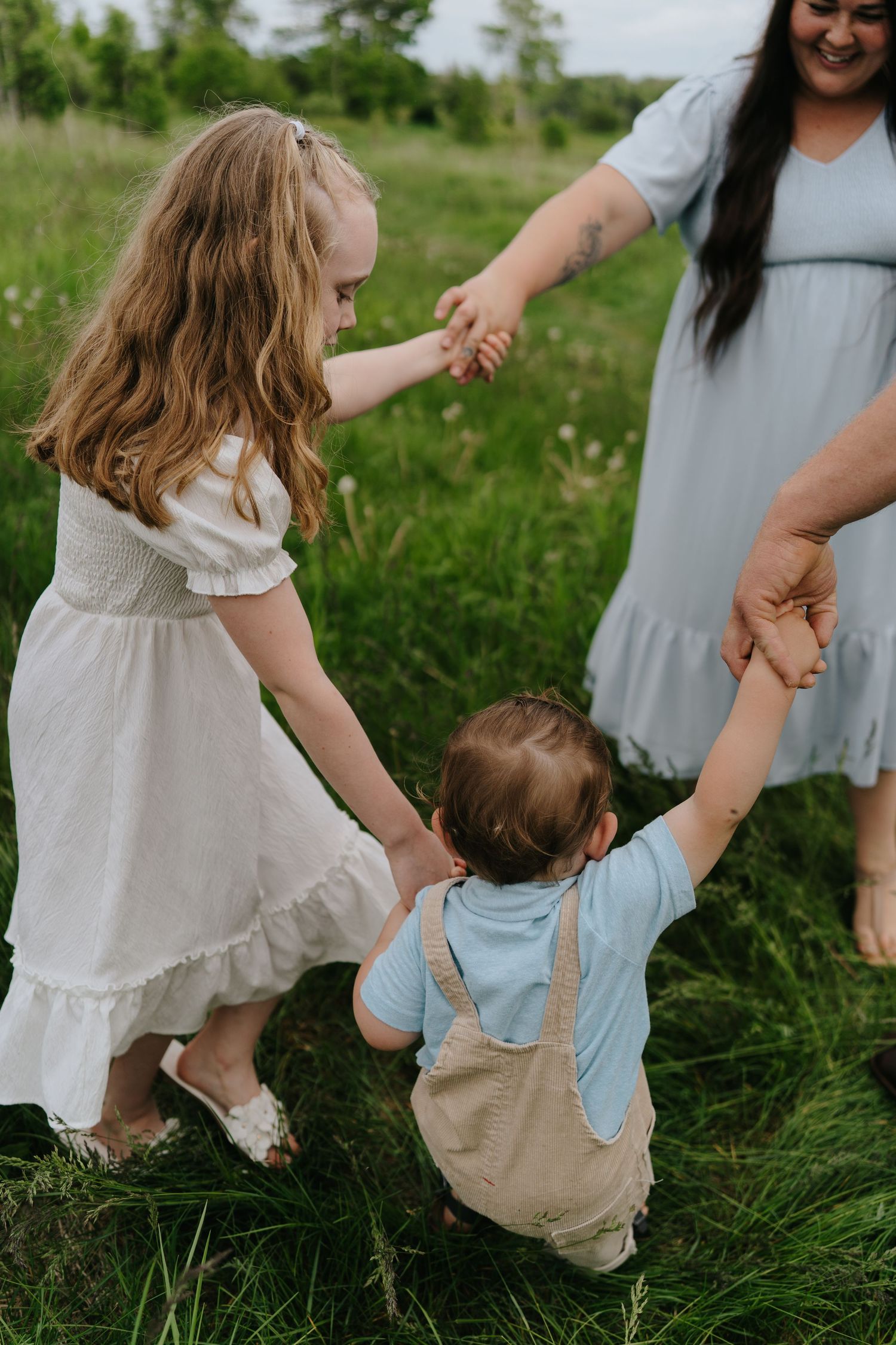 Family spending quality time together in a lush green summer field.