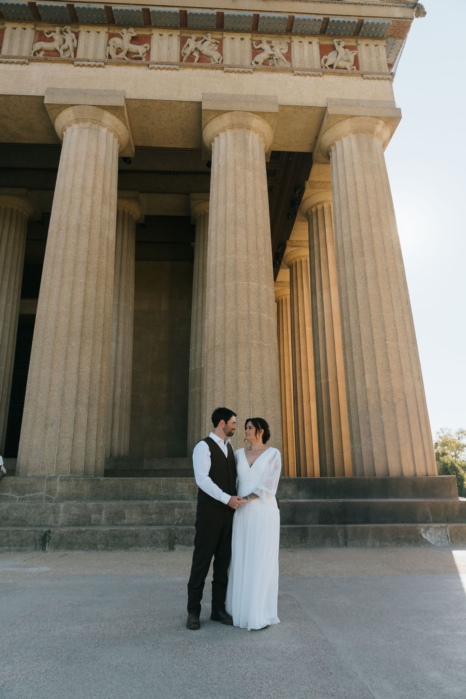 Wedding photos taken against grand classical columns of a historic building in Nashville, Tennessee