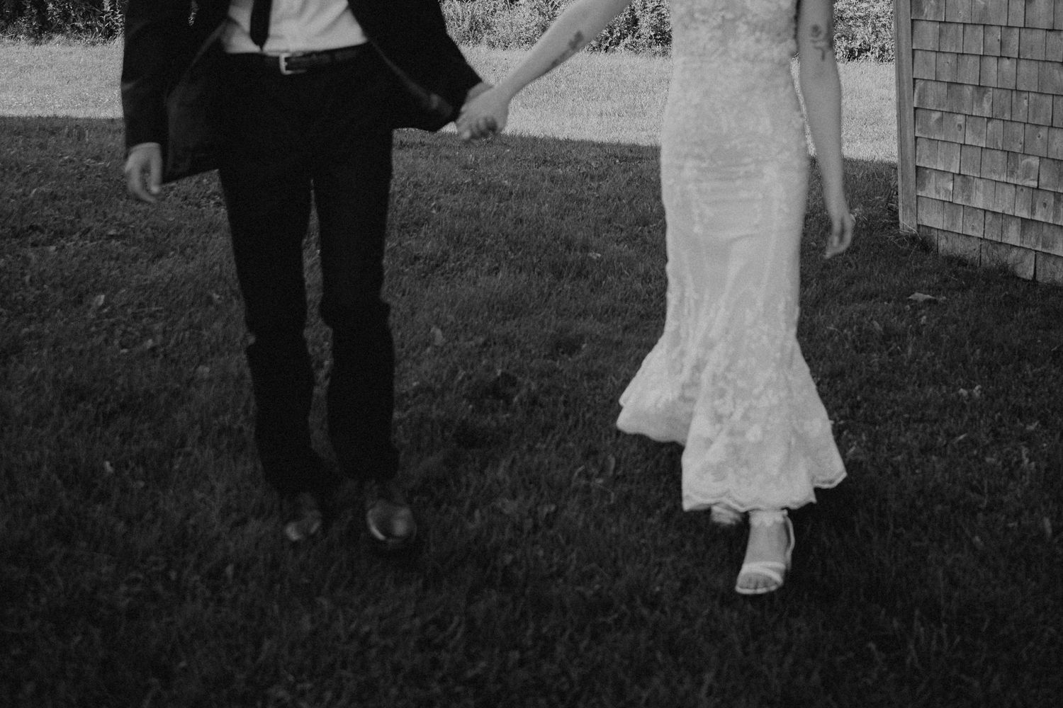 Elegant black and white wedding photo showing a couple dancing together in formal attire.