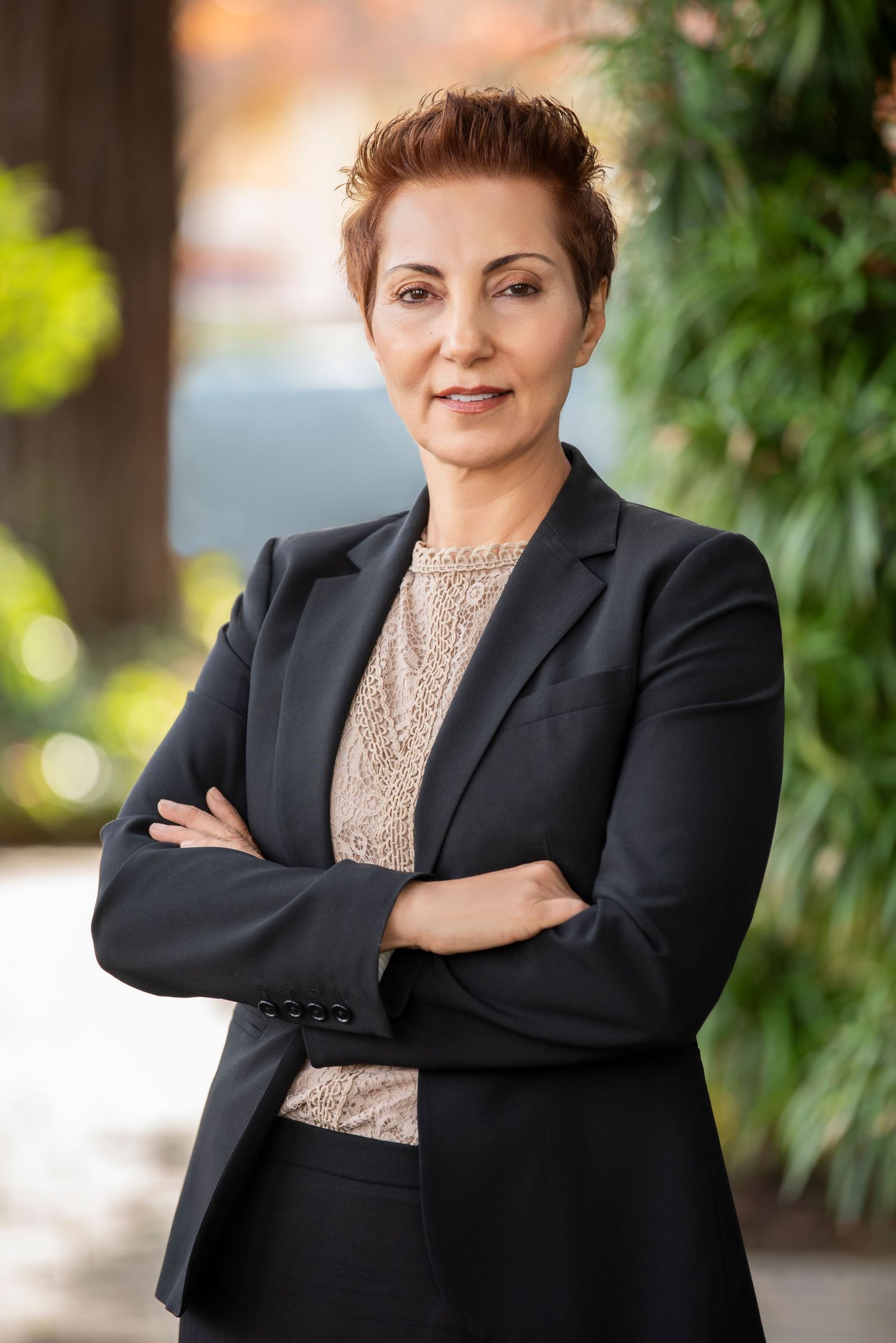 Professional portrait series showing a person in a black blazer and beige top against a blurred natural background.