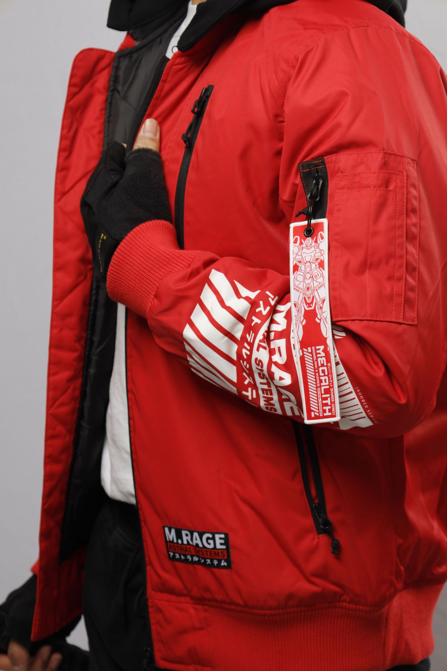 Red M.RAGE winter jacket with black accents shown with matching red and white gloves.