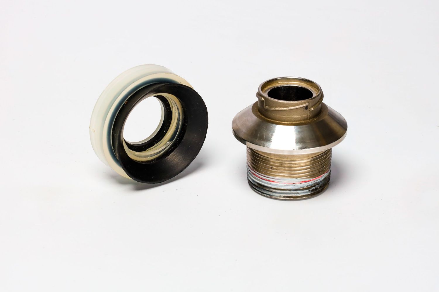 Close-up view of two metallic bike headset spacers showing threaded components and brushed metal finish.