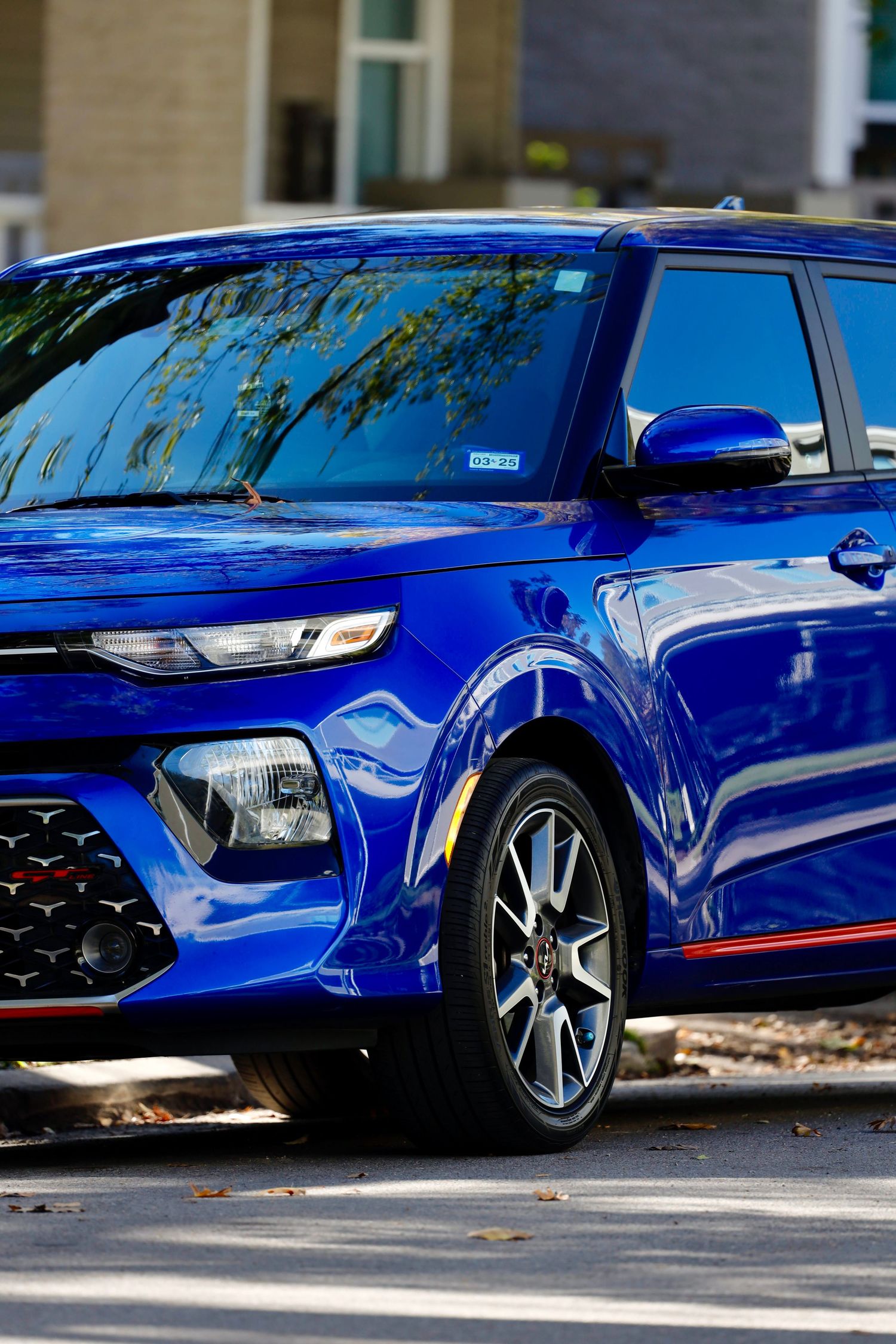 Bright blue Kia Soul showcasing its modern front design and LED headlights.